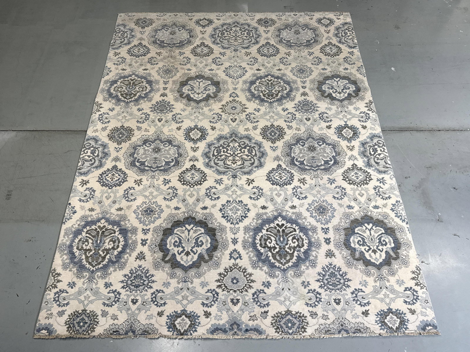 Lee Jofa hand knotted wool estate rug carpet with medallion pattern in shades of blue and gray on: Lee Jofa hand knotted wool estate rug carpet with medallion pattern in shades of blue and gray on cream ground, 9x12. 143? L x 108? W