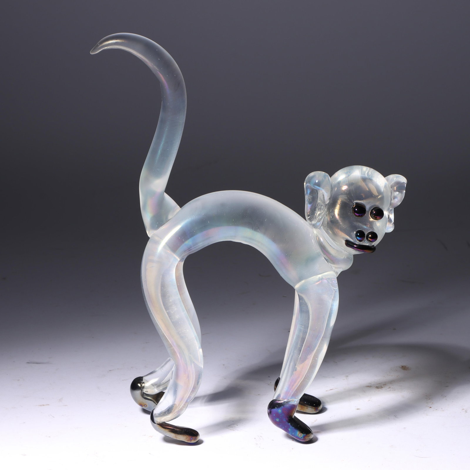 Ercole Barovier for Barovier and Toso Iridato Murano art glass monkey, 1930s 9 3/4"H x 7 1/2"W: Ercole Barovier for Barovier and Toso Iridato Murano art glass monkey, 1930s whimsical form of clear with applied dark amethyst face and feet, iridized surface 9 3/4"H x 7 1/2"W