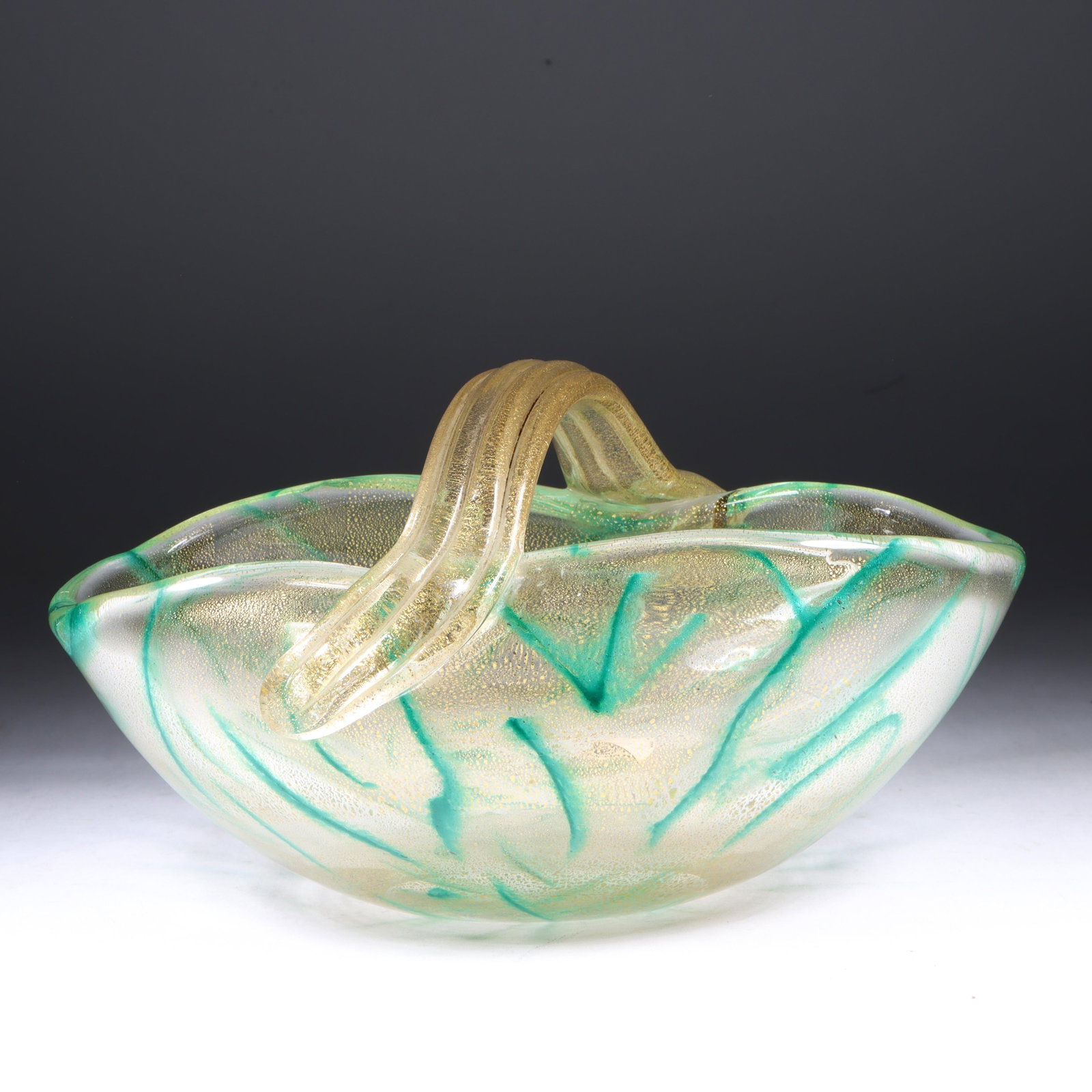 Archimede Seguso Murano art glass handled basket form 9" W x 6" D x 5" H: Archimede Seguso Murano art glass handled basket form Clear body internally decorated with deep green powder glass trails interior cased in gold leaf 9" W x 6" D x 5" H