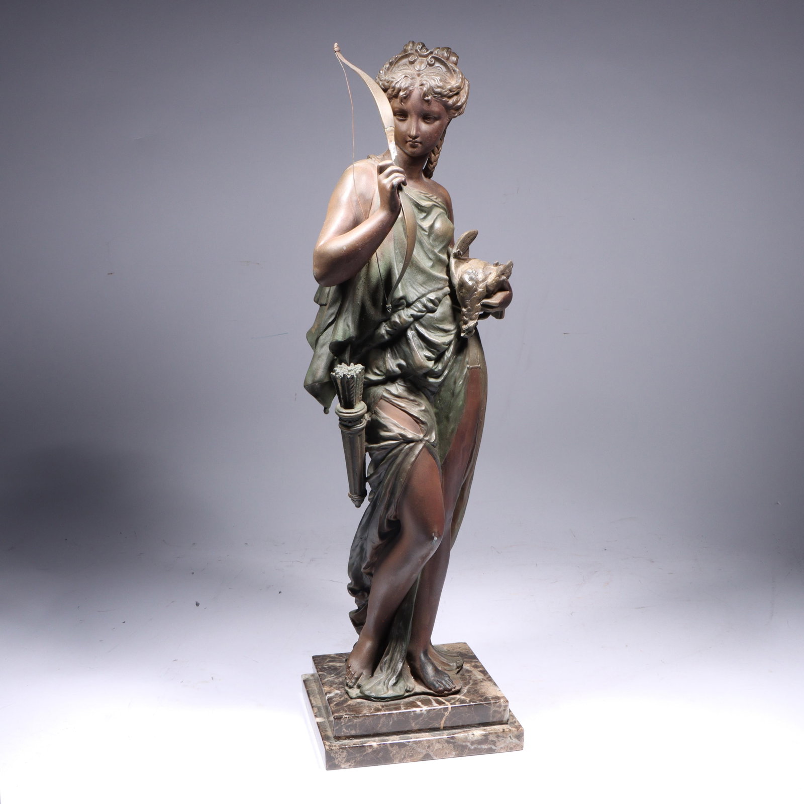 Continental (early 20th Century), Diana, the huntress, patinated metal statue on marble base, 21: Continental (early 20th Century) Diana, the huntress patinated metal statue on marble base Bow has been repaired. May be missing piece on top crown and an arrow? 21 1/2"H x 26 1/4"W