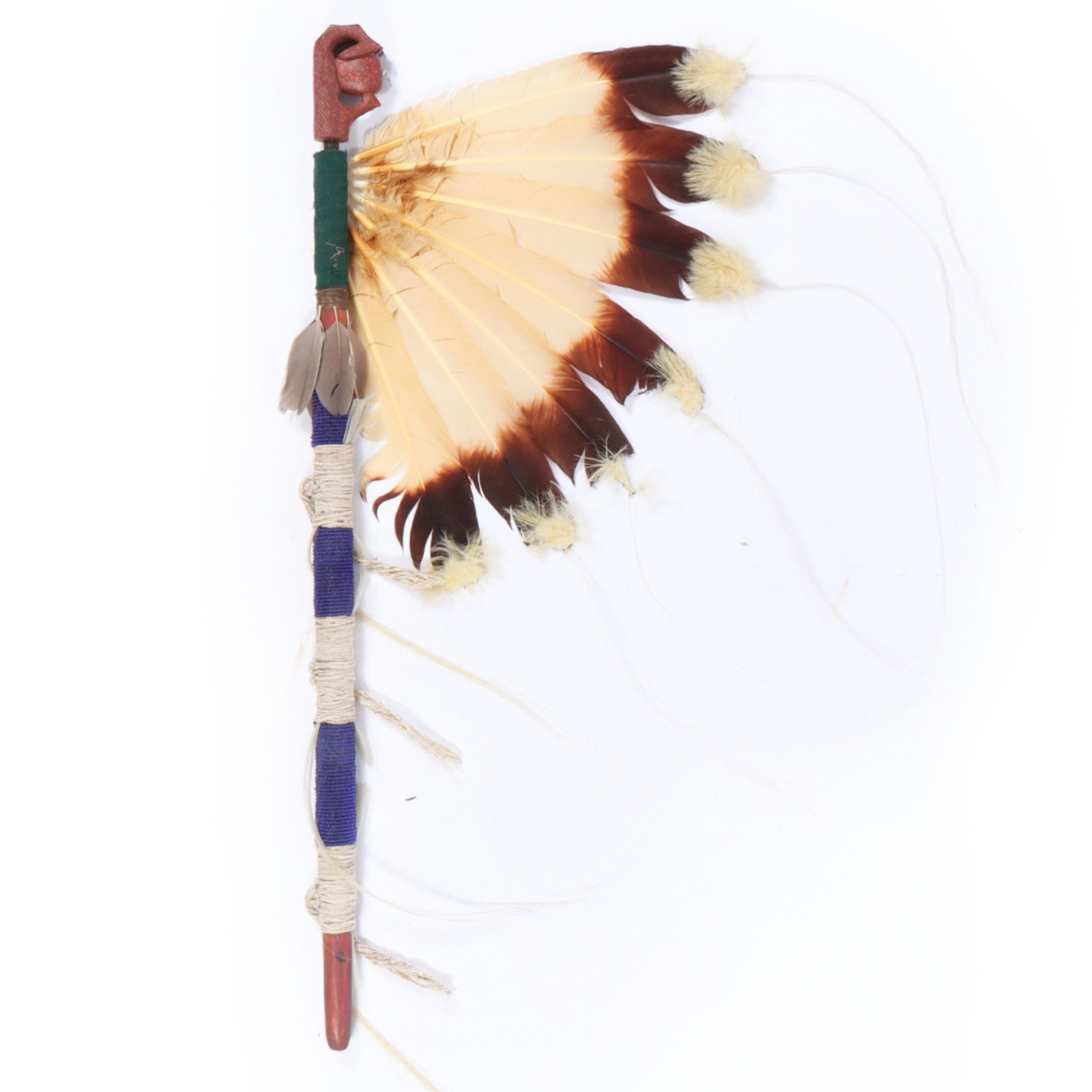 Native American ceremonial fan 31"H x 14 1/4"W: Native American ceremonial fan A Native American ceremonial fan featuring a handle wrapped in blue and white materials, adorned with feathers and decorative elements. The fan includes a carved figure 