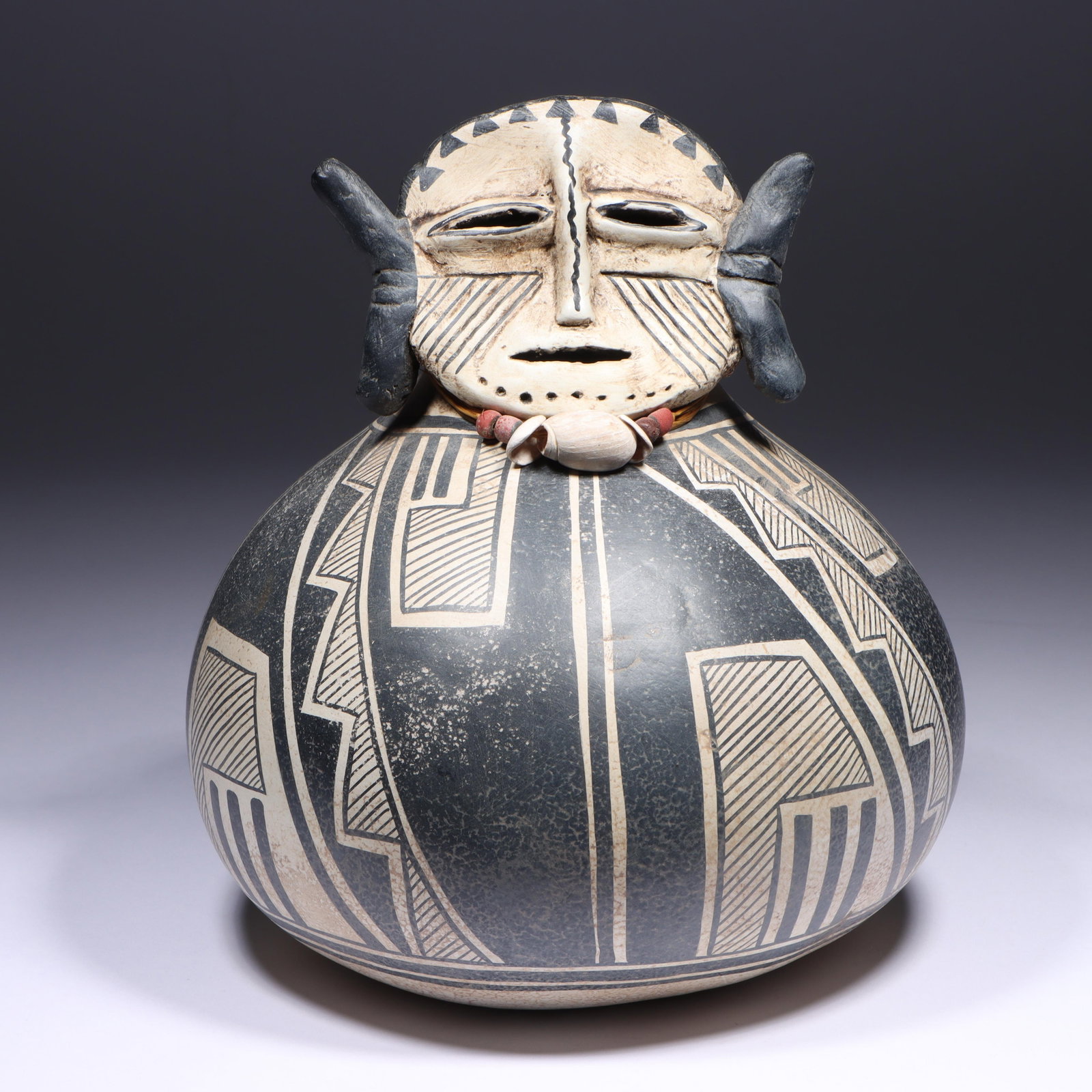 Robert Rivera (20th/21st century) Southwestern polychrome figural gourd sculpture with elongated: Robert Rivera (20th/21st century) Southwestern polychrome figural gourd sculpture with elongated ears and beaded necklace Signed and dated under base. Provenance: purchased 2/2000 Artist Spotlight fro