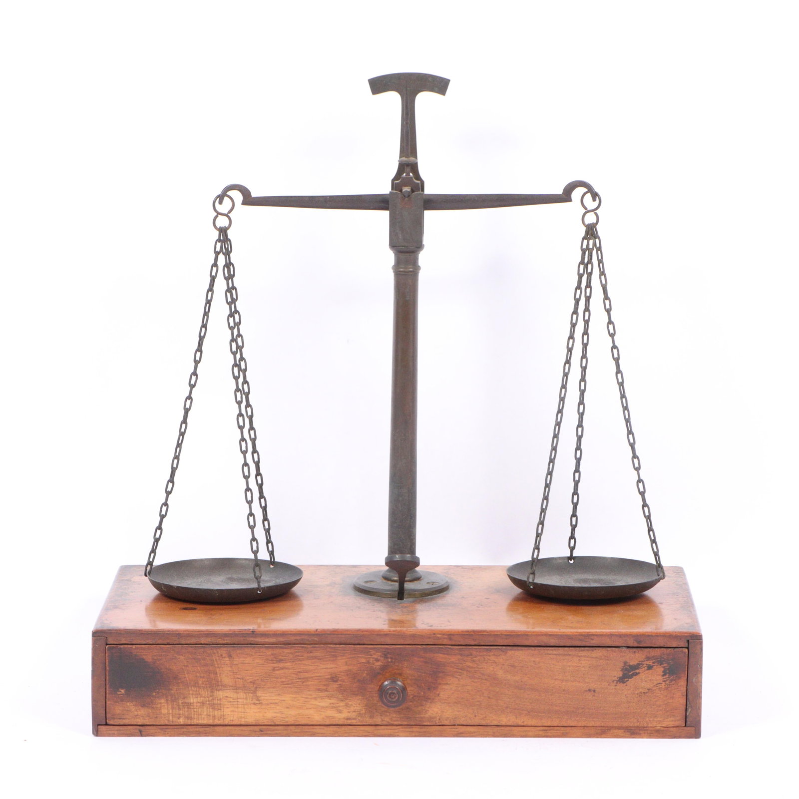 Cased Gold Scales 14"H x 13"W x 6 1/4"D: Cased Gold Scales An antique cased gold balance scale featuring a wooden base with a drawer and two metal pans suspended by chains. The scale is likely from the 19th century and was used for precise m