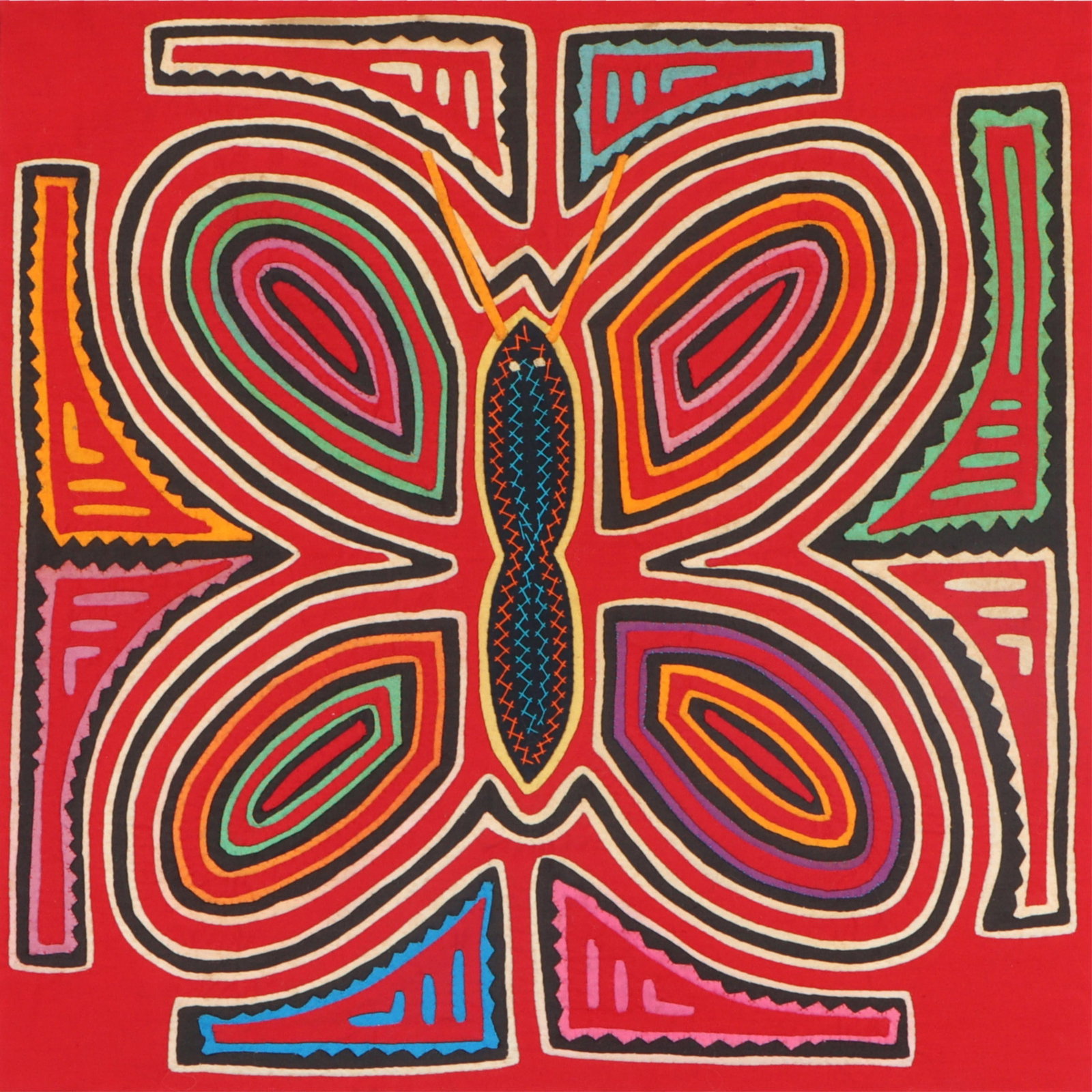 A South American mola handcrafted textile artwork. 17"H x 17"W(sight), 24"H x 24"W(frame): A South American mola handcrafted textile artwork. This is a framed textile artwork featuring a vibrant, symmetrical design with bold colors, likely created using traditional techniques. The piece app