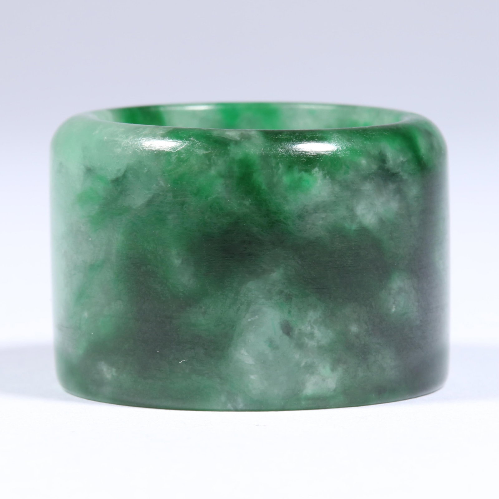 Variegated Green Chinese Jadeite Jade Hololith Band Archer's Ring Size 14: Variegated Green Chinese Jadeite Jade Hololith Band Archer's Ring Semi-translucency in good condition with no chips, or nicks; widespread surface abrasions. The width of the ring is 15/16" and the thi