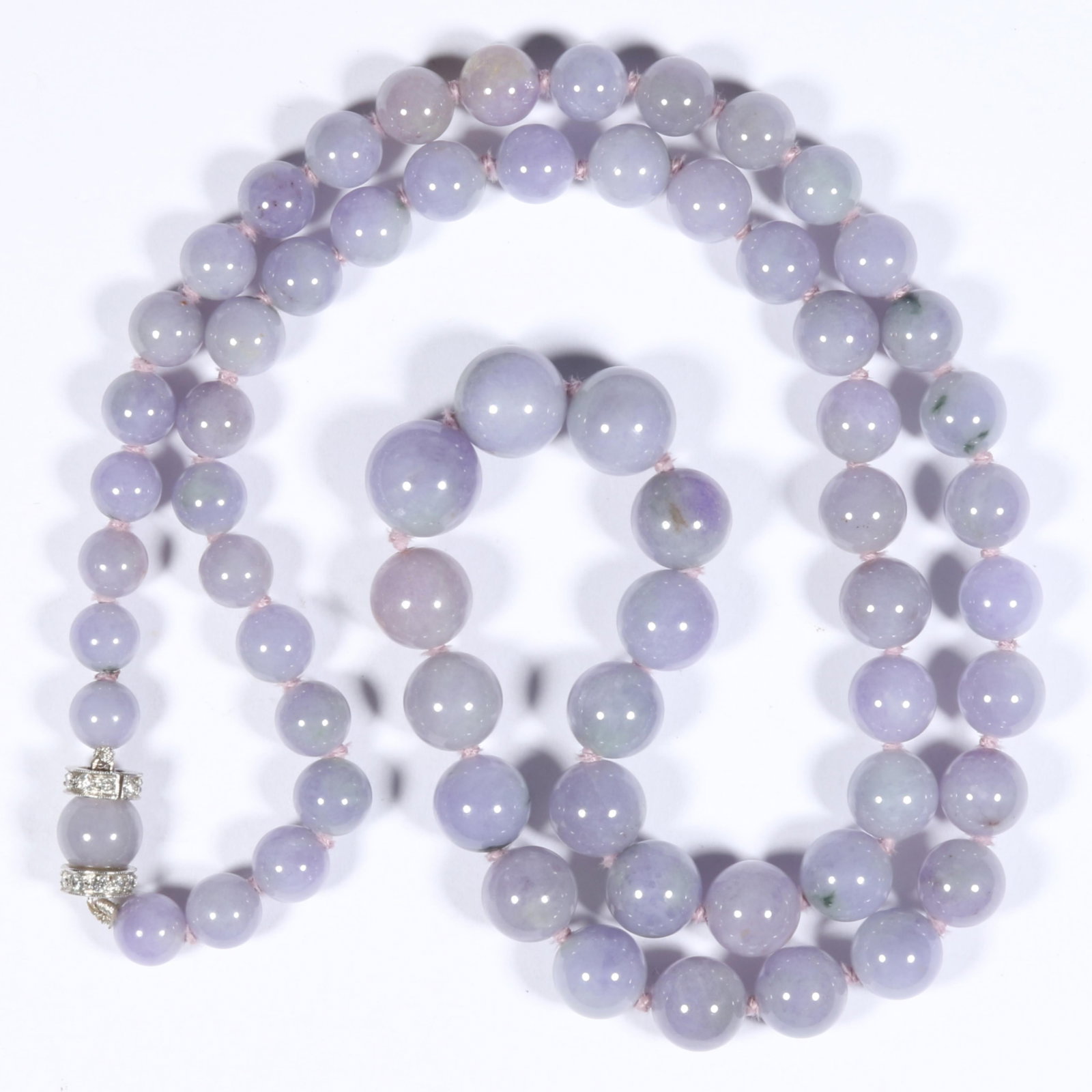 18K White Gold Lavender Chinese Jadeite Jade Knotted and Graduated Bead Necklace with Diamond: 18K White Gold Lavender Chinese Jadeite Jade Knotted and Graduated Bead Necklace with Diamond Rondelle Barrel Clasp 41.40dwt. Fine semi-translucency in very good condition with no chips, or nicks; min