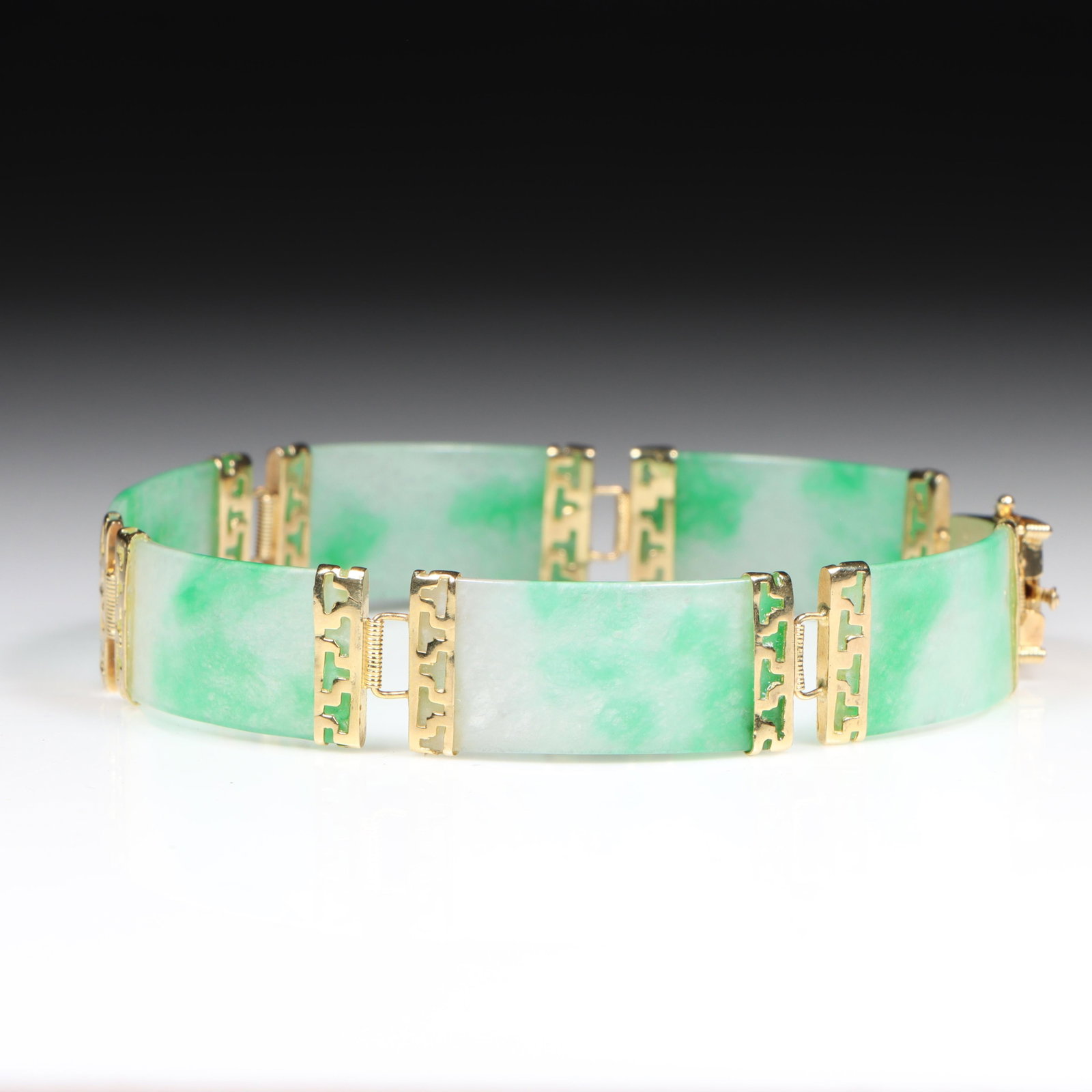 14K Yellow Gold Six Panel Apple Green Chinese Jadeite Jade Bracelet 7"L x 1/2"W: 14K Yellow Gold Six Panel Apple Green Chinese Jadeite Jade Bracelet 7.60 dwt. Jadeite exhibits fine semi-translucency and is in very good condition with no chips, nicks, or cracks. The purchase of gol