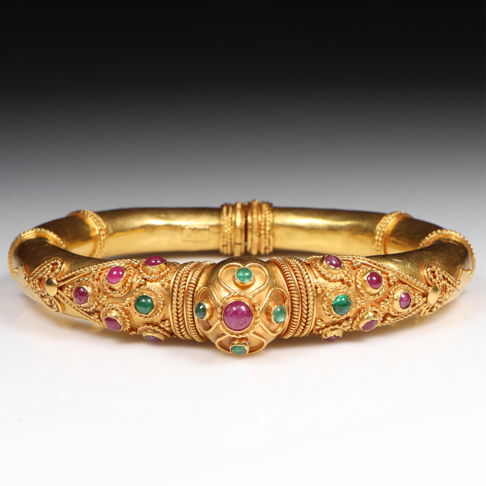 22K Yellow Gold Mughal Style Hinged Bangle Bracelet Set with Ruby and Emerald Cabochons 1/2"Wide x 2: 22K Yellow Gold Mughal Style Hinged Bangle Bracelet Set with Ruby and Emerald Cabochons 30.00 dwt The purchase of gold requires confirmed funds. 1/2"Wide x 2 1/4" inner Dimen.