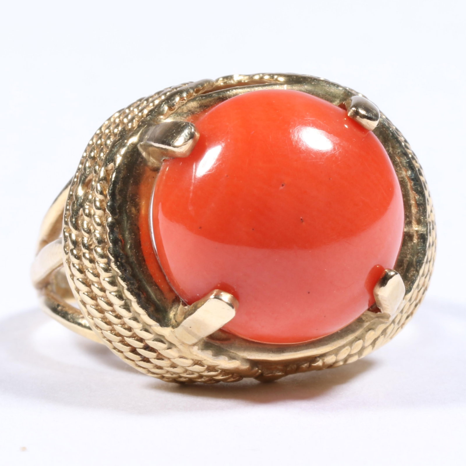 10K Yellow Gold Coral Cabochon Cocktail Ring with Textured Gold Details Size 5 1/2: 10K Yellow Gold Coral Cabochon Cocktail Ring with Textured Gold Details 3.50 dwt. The center stone measures 12.50mm round The purchase of gold requires confirmed funds. Size 5 1/2