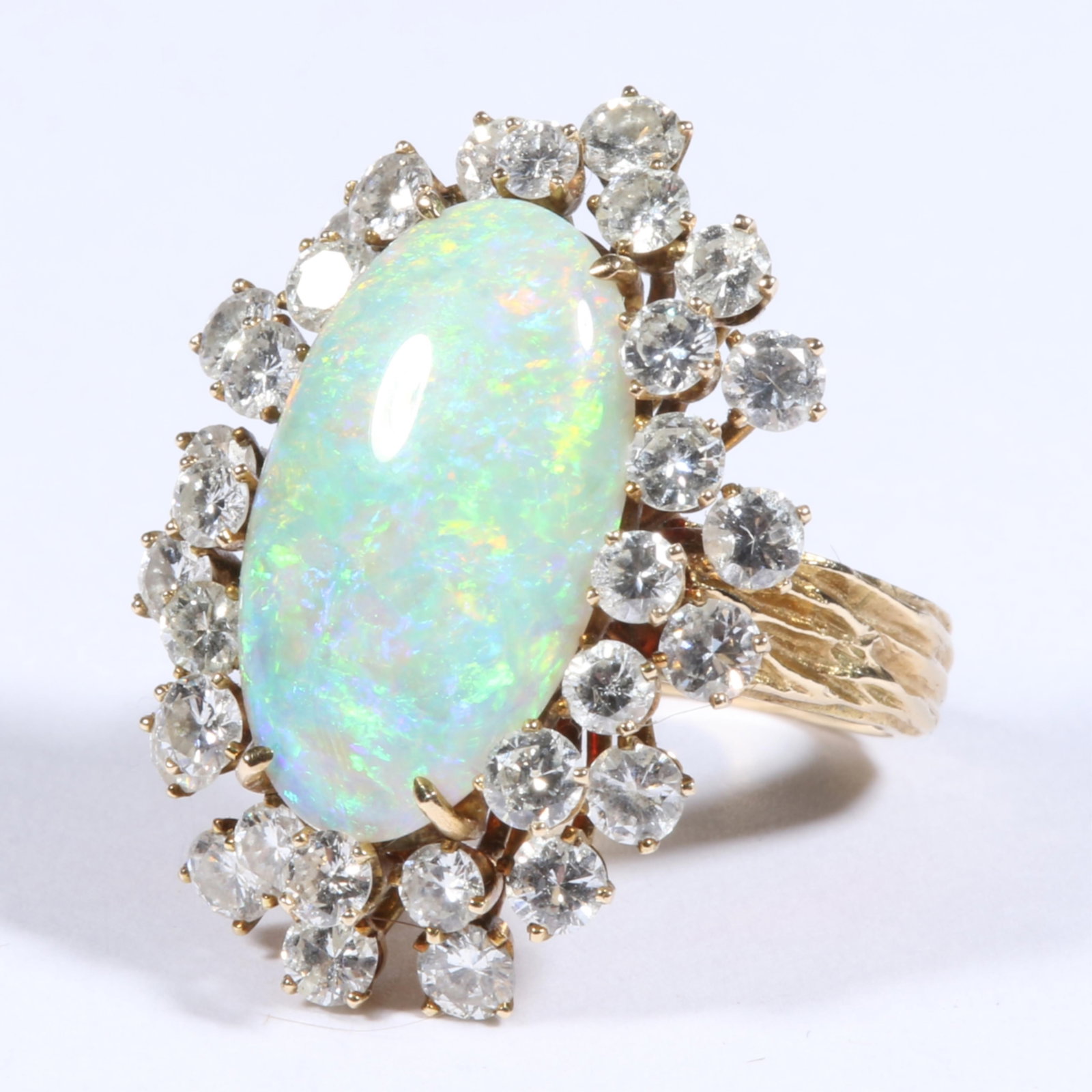 14K Yellow Gold Cocktail Ring with White Opal surrounded by a Halo of Brilliant Cut Diamonds Size 5: 14K Yellow Gold Cocktail Ring with White Opal surrounded by a Halo of Brilliant Cut Diamonds 6.28dwt. 1 - 19mm x 11mm oval opal cabochon. 32 - round brilliant cut diamonds 2.15tcw. H, I color - I1 cla