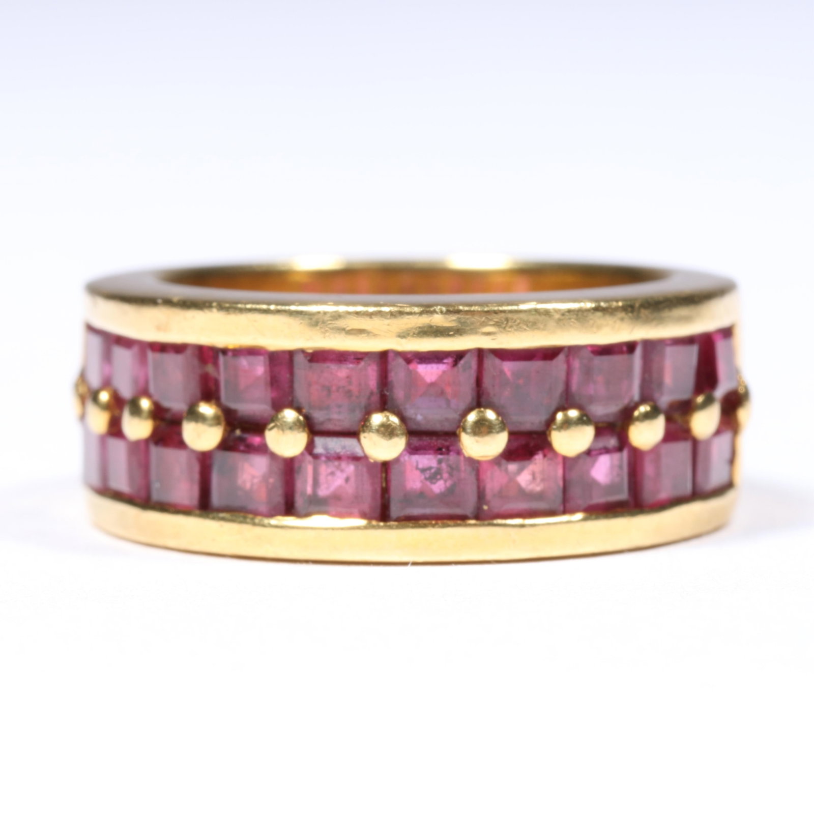 18K Yellow Gold Custom Made Channel and Bead Set Ruby Ring Size 7: 18K Yellow Gold Custom Made Channel and Bead Set Ruby Ring 9.46 dwt. The inside is stamped "P21." The rubies are synthetic. The purchase of gold requires confirmed funds. Size 7