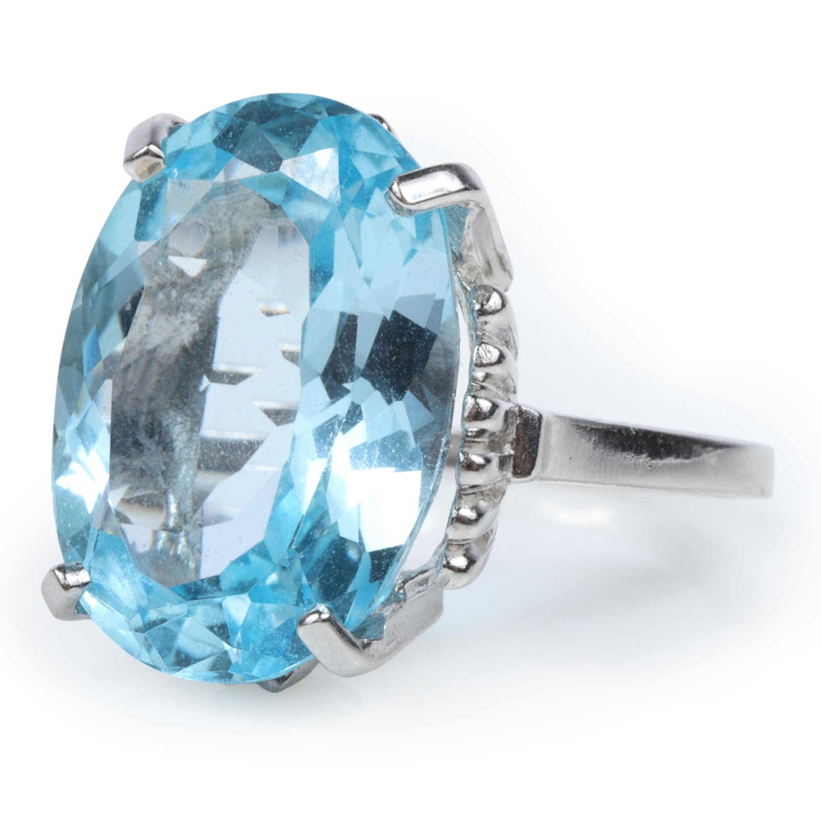 10K White Gold Blue Topaz in Four Prong High Profile Setting, Approx. 40Cts. Size 7 1/2: 10K White Gold Blue Topaz in Four Prong High Profile Setting, Approx. 40Cts. 5.68dwt. The blue topaz measures approx. 20mm x 15mm x 19.25mm and weighs approx. 40 cts. The purchase of gold requires con