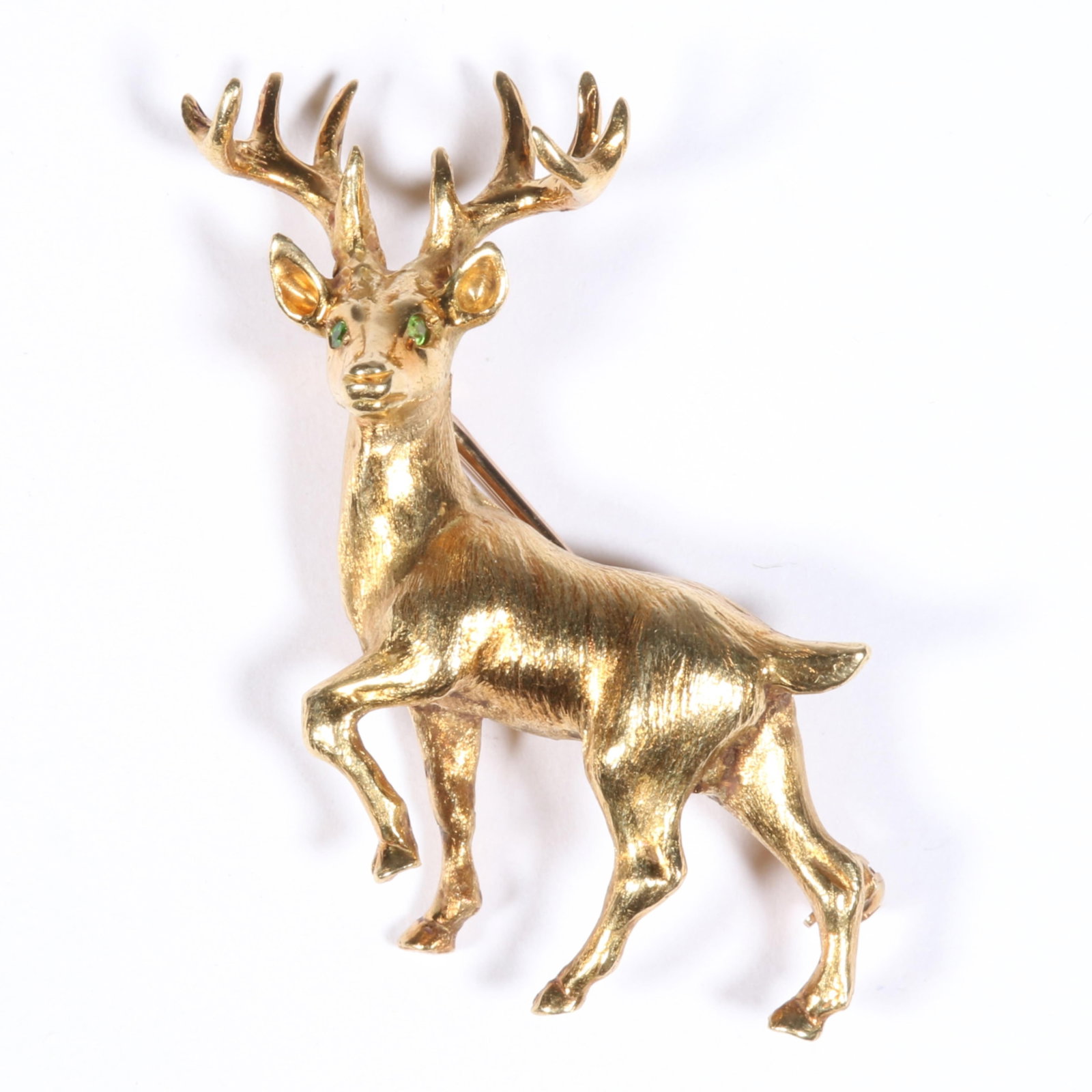 18K Yellow Gold Ten Point Stag Brooch with Peridot Eyes 1 7/8"H x 1 3/8"W x 1/2"D: 18K Yellow Gold Ten Point Stag Brooch with Peridot Eyes 7.82 dwt. 2 - 1.25mm round peridot. The purchase of gold requires confirmed funds. 1 7/8"H x 1 3/8"W x 1/2"D