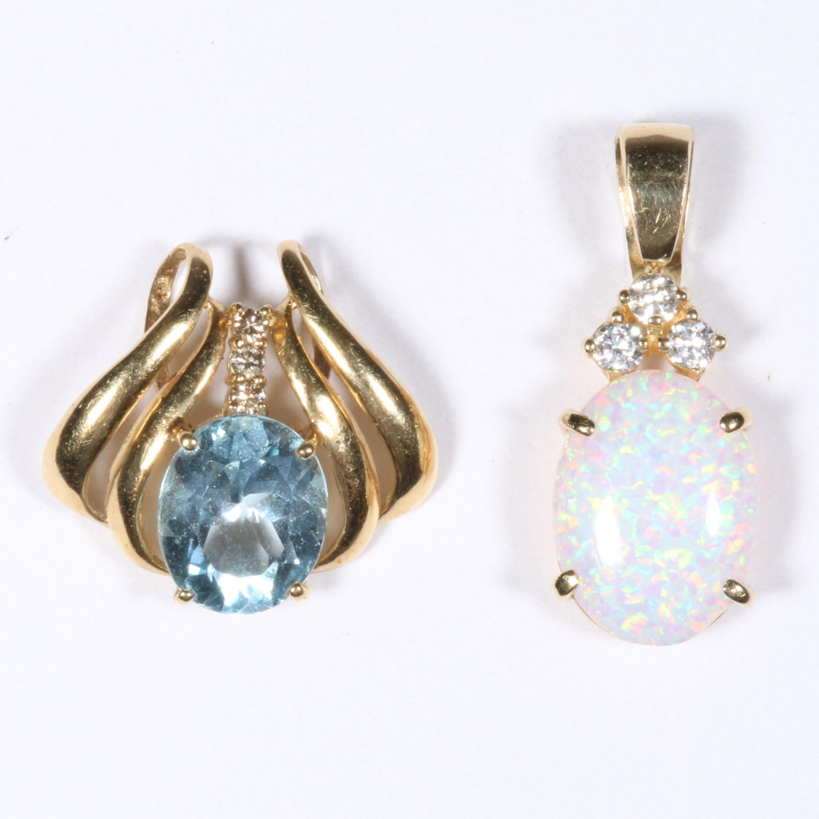 14K Yellow Gold Blue Topaz Pendant with 14K Yellow Gold Faux Opal and CZ Pendant 1 1/4"H x 1/2"W: 14K Yellow Gold Blue Topaz Pendant with 14K Yellow Gold Faux Opal and CZ Pendant 2.55 dwt (topaz) 2.10 dwt (opal) The purchase of gold requires confirmed funds. 1 1/4"H x 1/2"W