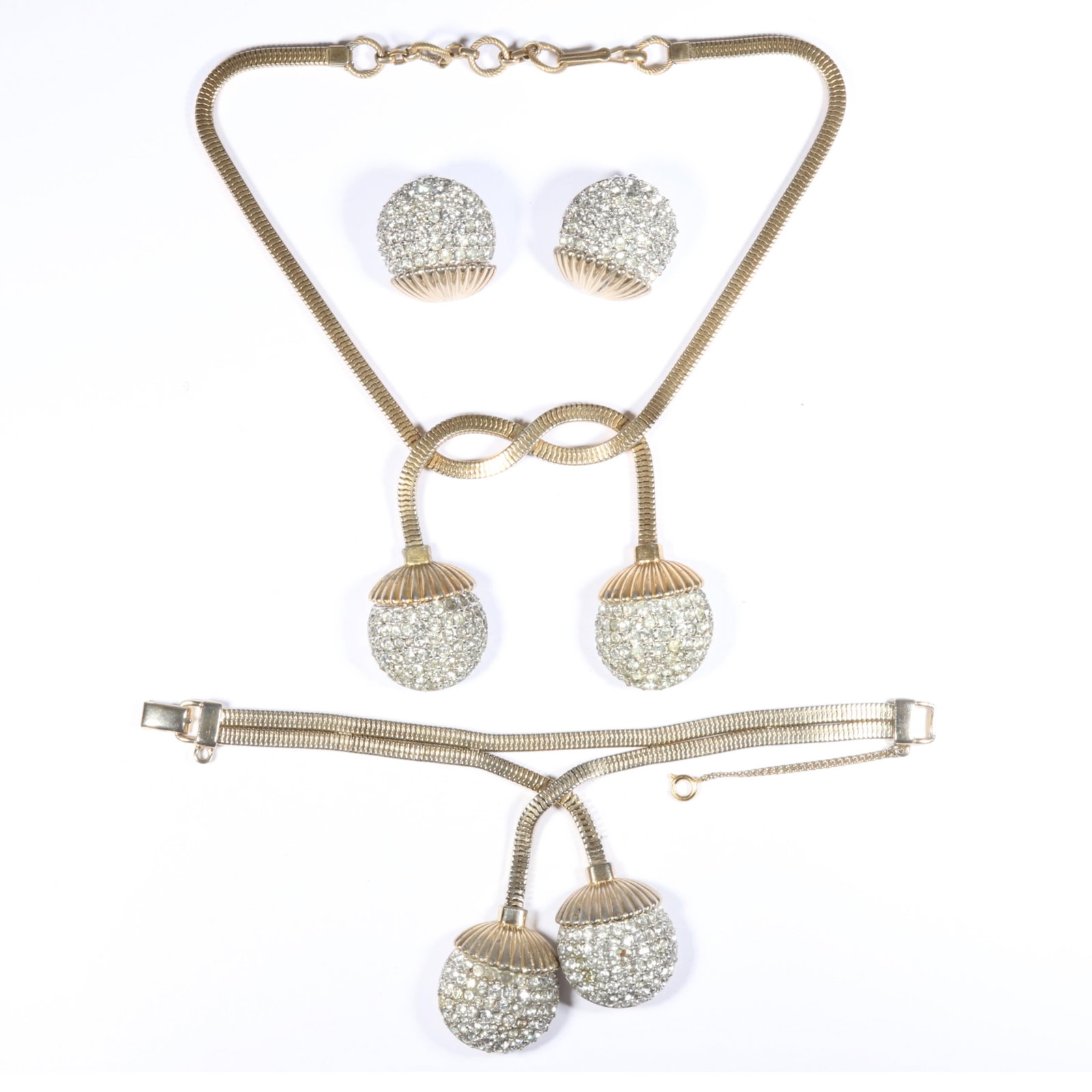 Schiaparelli 1950's book piece ball and chain parure with flexible gold snake chains that end in: Schiaparelli 1950's book piece ball and chain parure with flexible gold snake chains that end in pave rhinestone balls. Includes necklace, bracelet, and earrings. "Fabulous Fakes" by Carole Tanenbaum,