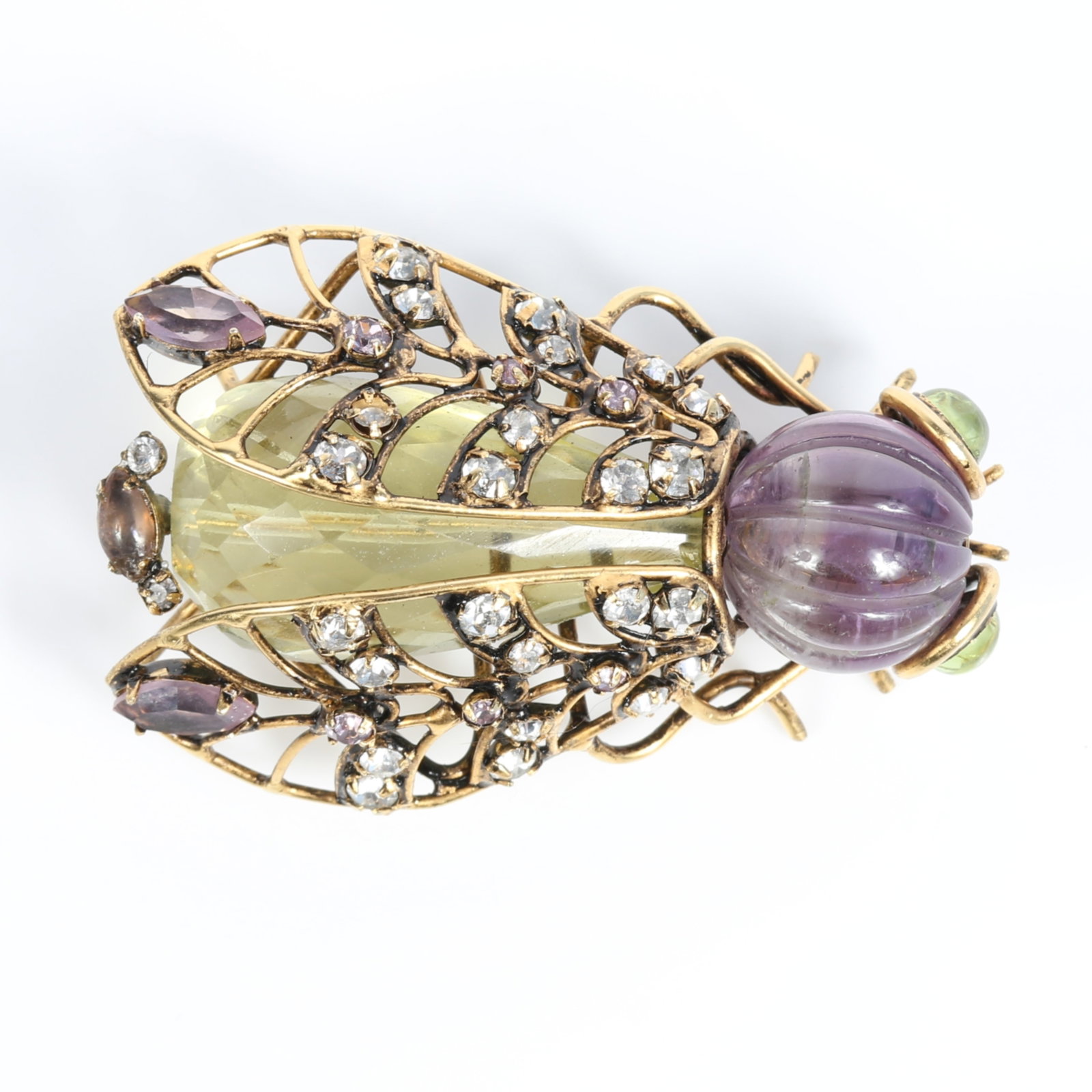 Iradj Moini insect / bug brooch with with carved amethyst head, citrine body, green glass eyes, and: Iradj Moini insect / bug brooch with with carved amethyst head, citrine body, green glass eyes, and rhinestone crystal accents on gold plated wire frame 2 1/2"H x 1 5/8"W