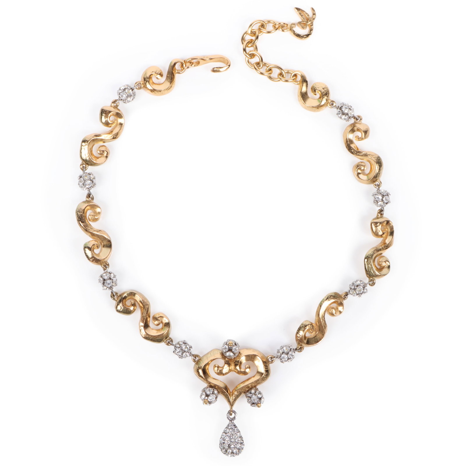 Christian Lacroix necklace with chain composed of S-shaped scrolls interspersed with clear: Christian Lacroix necklace with chain composed of S-shaped scrolls interspersed with clear crystal-accented links and central heart shaped pendant with crystal drops 17 1/2"L x 2 1/8"Drop