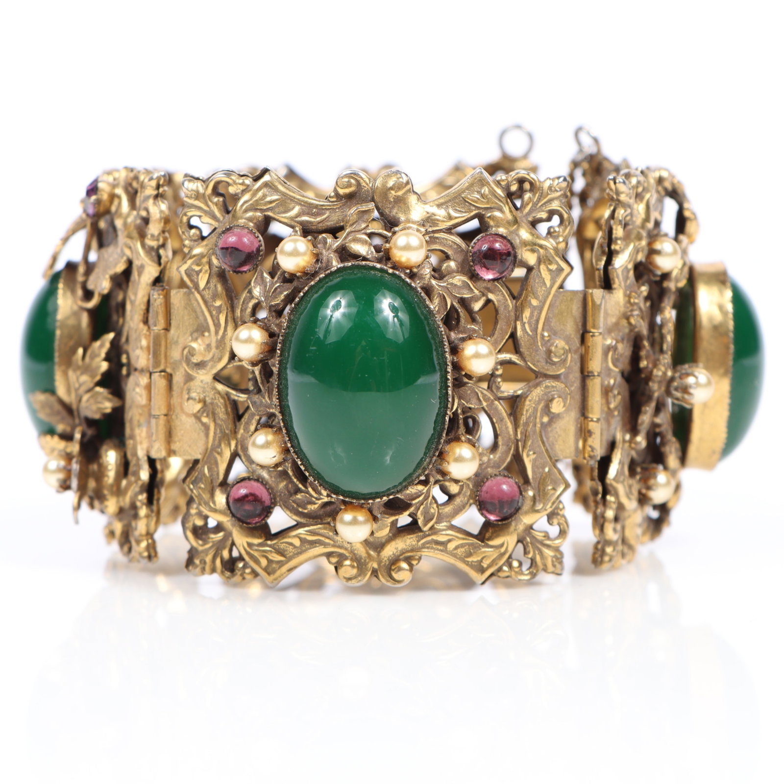 Ornate mid century panel bracelet with large green glass cabochons, faux pearls, amethyst glass, and: Ornate mid century panel bracelet with large green glass cabochons, faux pearls, amethyst glass, and gilt foliage 7 1/2"Long x 1 3/4"W