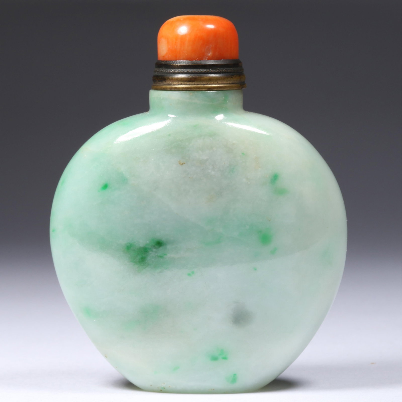 Chinese Moss-in-Snow carved Jadeite Jade Snuff Bottle with original Coral Stopper 3 1/2"H x 2 5/8"W: Chinese Moss-in-Snow carved Jadeite Jade Snuff Bottle with original Coral Stopper Wound cloth stopper fits securely into the bottle. 3 1/2"H x 2 5/8"W x 1 1/8"D