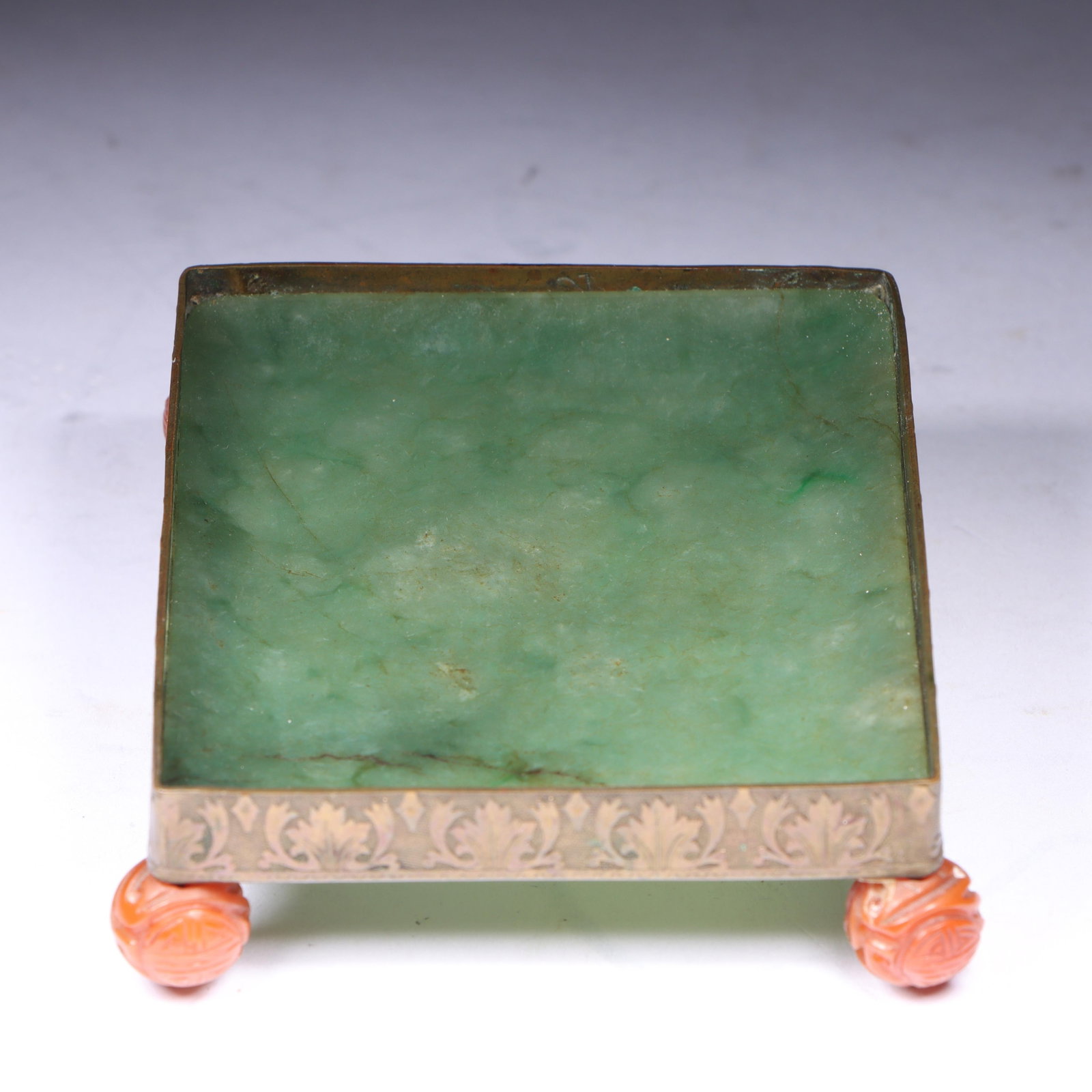Chinese jade opium dish stand with embossed brass base and carved coral bead feet 1"H x 3 1/4"W x 2: Chinese jade opium dish stand with embossed brass base and carved coral bead feet 1"H x 3 1/4"W x 2 3/4"D