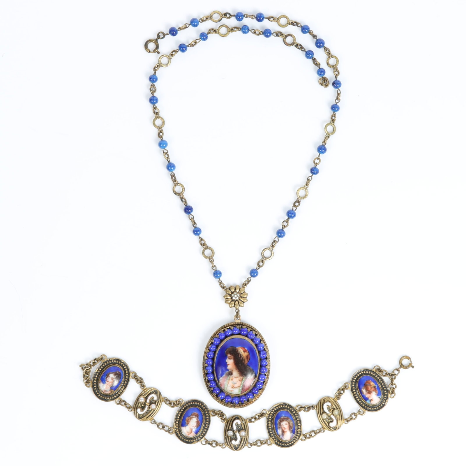 1920's Czech hand painted portrait brass necklace and bracelet set with blue Czech glass beads and: 1920's Czech hand painted portrait brass necklace and bracelet set with blue Czech glass beads and white enamel details, possibly Neiger Brothers Provenance: From the Collection of Joan Duran, owner o