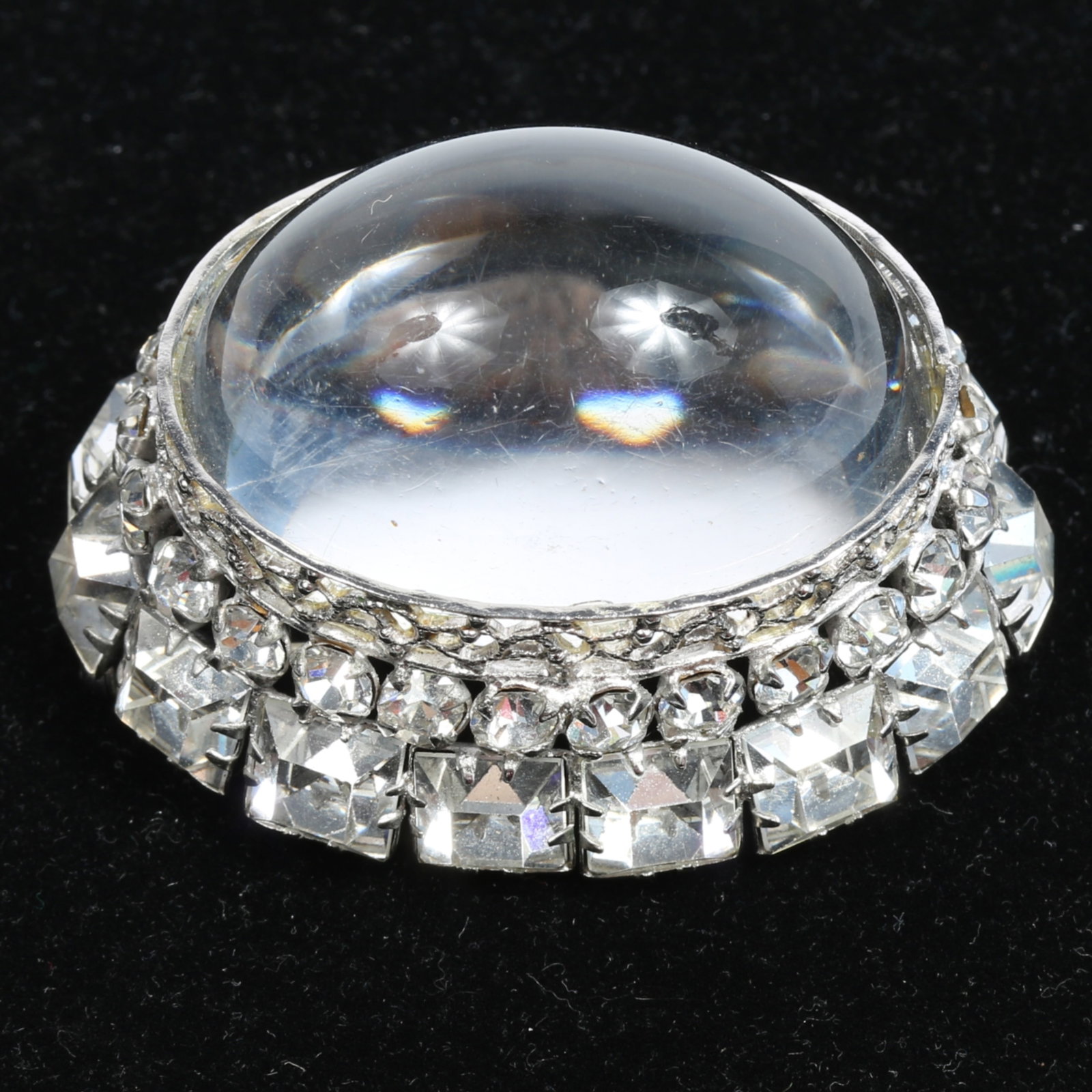 Schreiner New York mile high dome brooch clear jelly cabochon brooch surrounded by an elaborate: Schreiner New York mile high dome brooch clear jelly cabochon brooch surrounded by an elaborate collar of rhinestone crystals Provenance: From the private collection of Dr. Claudia Brodhead 2 1/8"H x 
