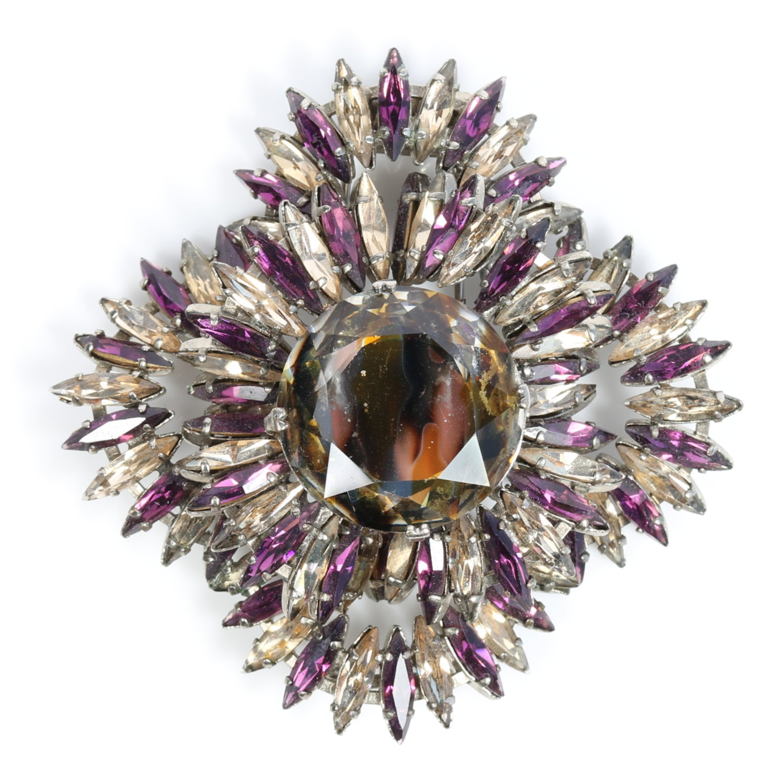 French fur clip, likely Roger Jean-Pierre, with gold and black flame pattern center jewel surrounded: French fur clip, likely Roger Jean-Pierre, with gold and black flame pattern center jewel surrounded by purple and champagne fluted skirt of marquise crystals Signed "Depose" and "France" Provenance: 