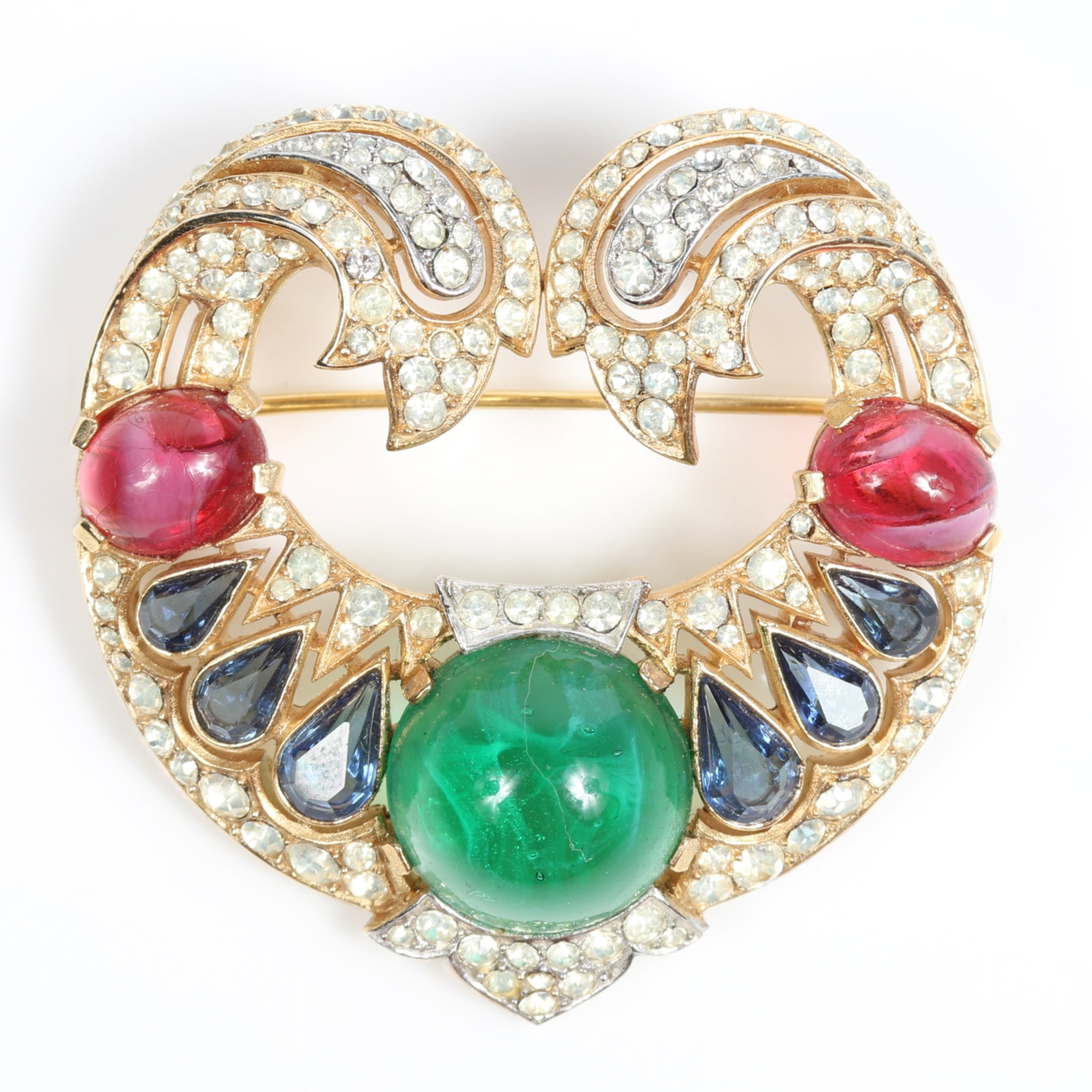Crown Trifari Jewels of India Moghul brooch with emerald and ruby cabochon stones, sapphire jewels,: Crown Trifari Jewels of India Moghul brooch with emerald and ruby cabochon stones, sapphire jewels, and pave diamante rhinestones Provenance: From the private collection of Dr. Claudia Brodhead 1 3/4"