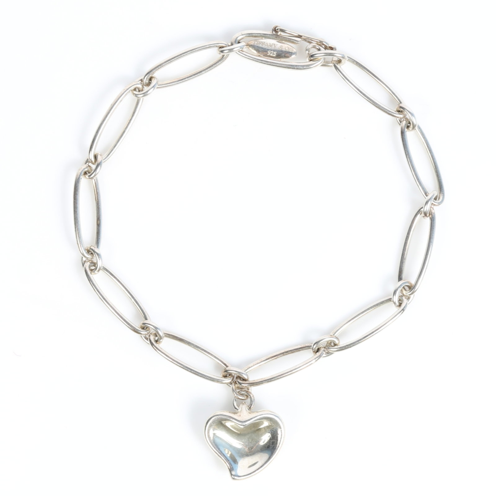 Tiffany & Co. Elsa Peretti sterling silver charm bracelet with heart charm, with original box and: Tiffany & Co. Elsa Peretti sterling silver charm bracelet with heart charm, with original box and dust bag Provenance: From the Collection of Joan Duran, owner of The Queen's Bedroom on Facebook 7 1/4