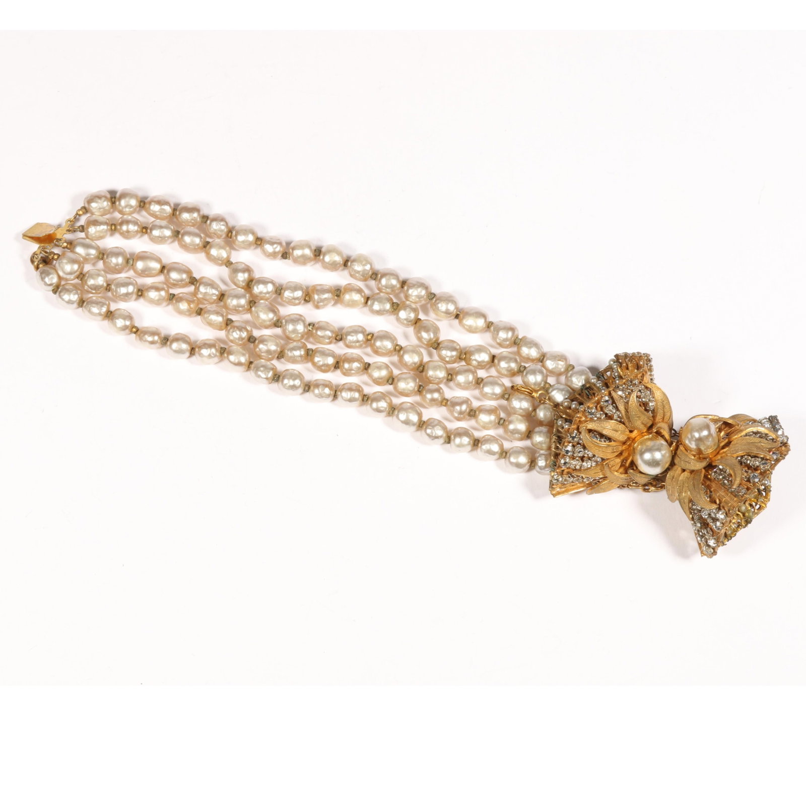Miriam Haskell multi strand faux pearl bracelet with dimensional gilt clasp with leaf design, seed: Miriam Haskell multi strand faux pearl bracelet with dimensional gilt clasp with leaf design, seed pearls, and rhinestones Some loss of seed pearls on inside of clasp Provenance: From the Collection o