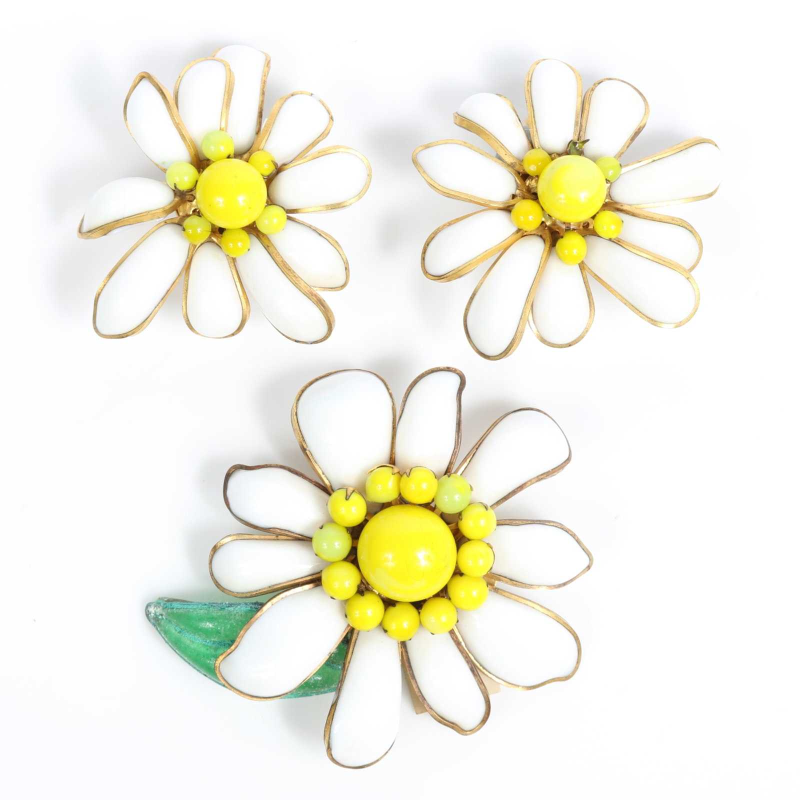 Jean Patou French couture pate de verre poured glass daisy floral brooch and matching earrings, with: Jean Patou French couture pate de verre poured glass daisy floral brooch and matching earrings, with original paper tag One earring is missing one small yellow bead Provenance: From the private collec