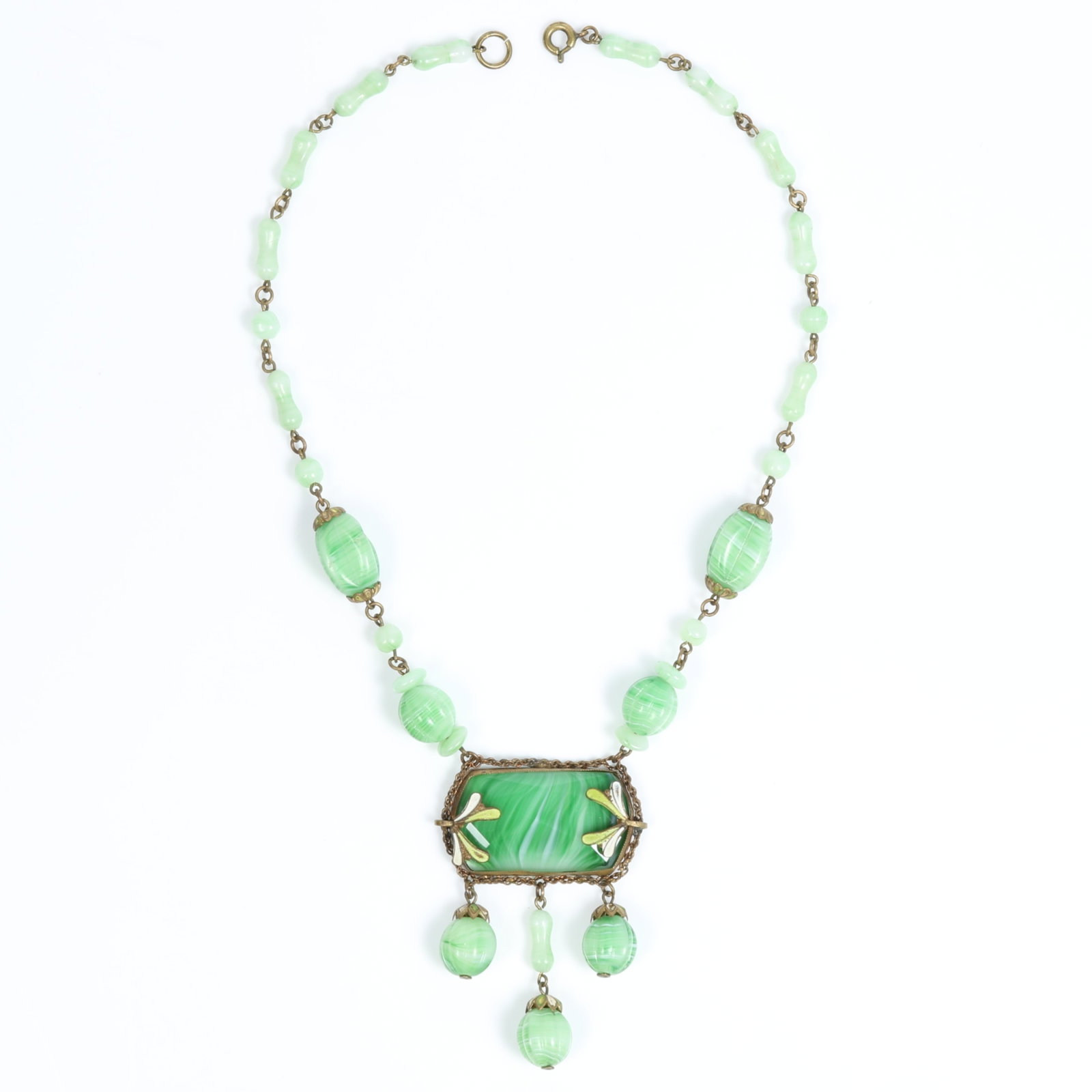 Variegated green Czech glass fluted bead necklace with green and white enamel floral details 15"L x: Variegated green Czech glass fluted bead necklace with green and white enamel floral details Provenance: From the private collection of Dr. Claudia Brodhead 15"L x 2 1/2" Drop