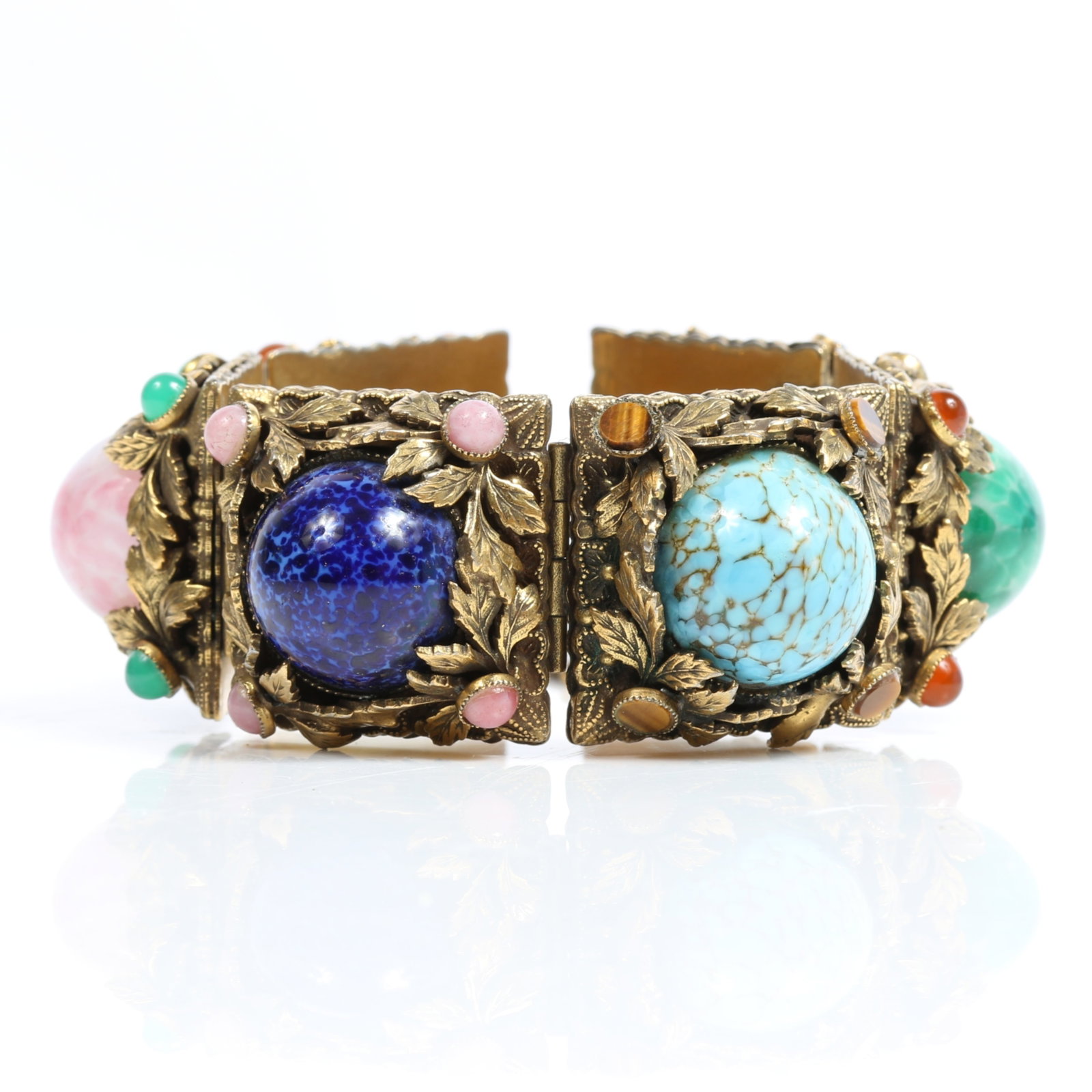 Heavy Mid Century panel bracelet with huge art glass cabochon stones and floral accents 7 1/8"L x 1: Heavy Mid Century panel bracelet with huge art glass cabochon stones and floral accents Missing one small green cabochon Provenance: From the private collection of Dr. Claudia Brodhead 7 1/8"L x 1 1/8