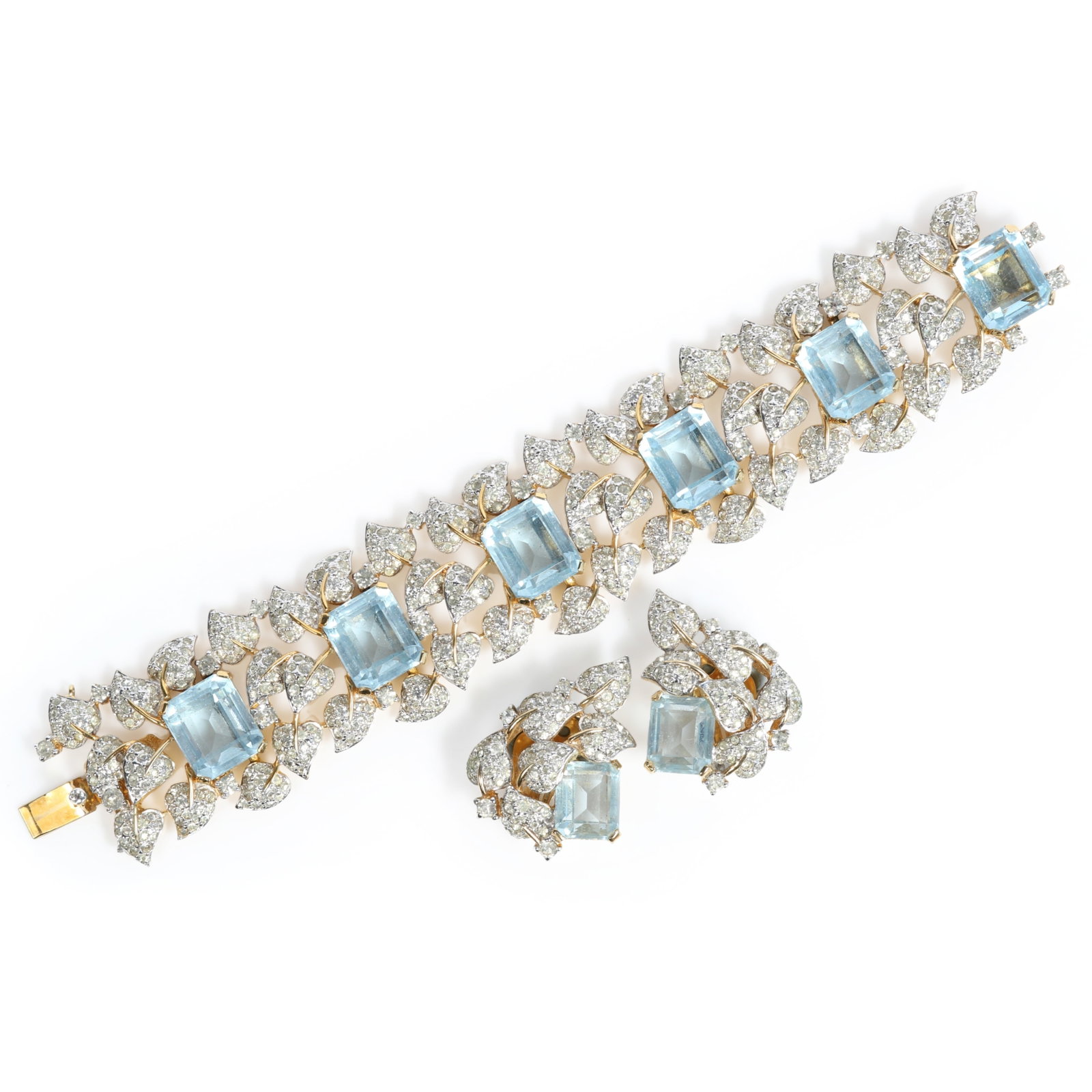 Jomaz pave diamante ivy leaves and aquamarine emerald cut rhinestone crystal bracelet and matching: Jomaz pave diamante ivy leaves and aquamarine emerald cut rhinestone crystal bracelet and matching earrings Provenance: From the private collection of Dr. Claudia Brodhead 6 3/4"L x 1 1/4"W (bracelet)