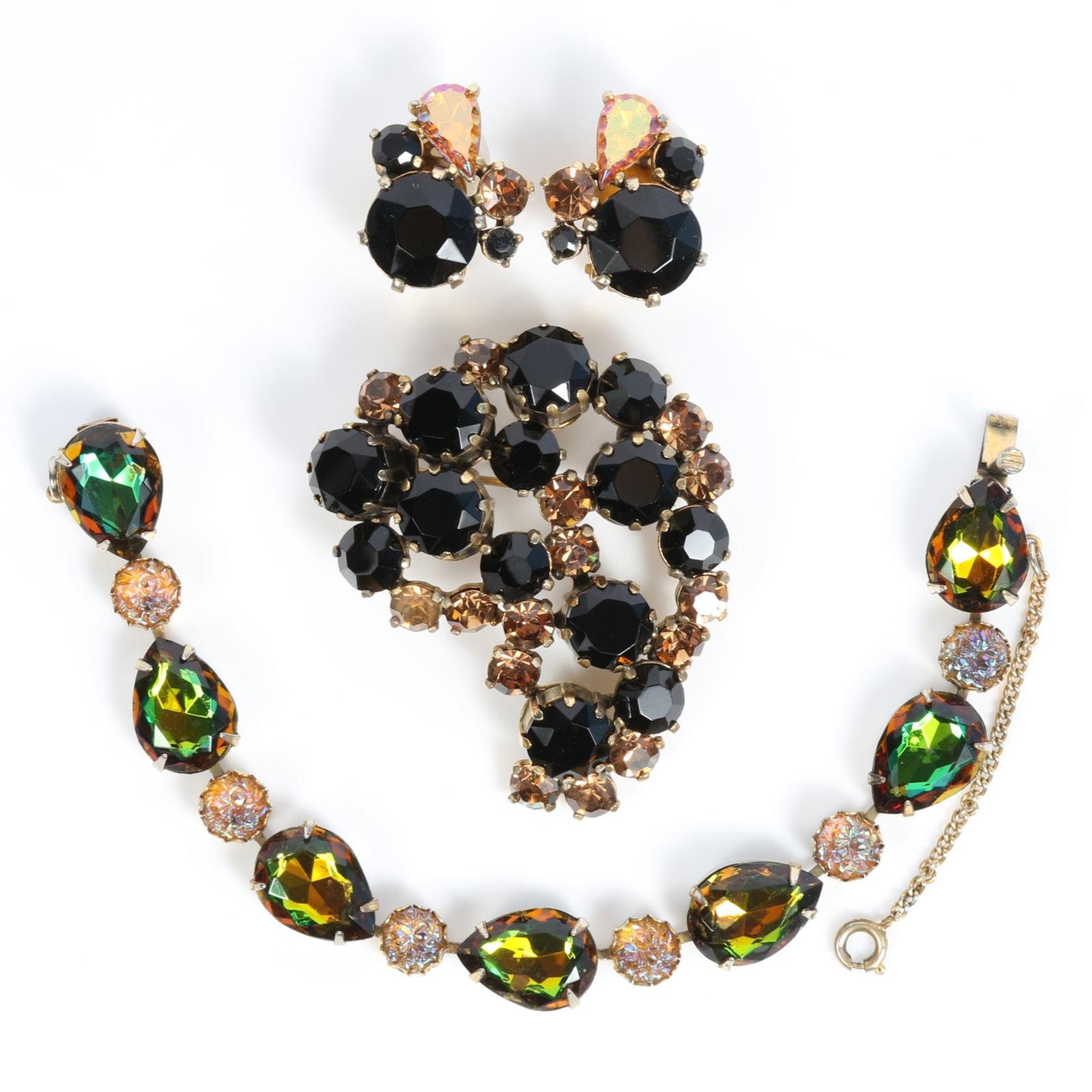 Schiaparelli 3pc group: matching brooch and earrings with large faceted iridescent amber / green: Schiaparelli 3pc group: matching brooch and earrings with large faceted iridescent amber / green color change jewels, black rhinestone crystals and rich champagne accent jewels, and watermelon tourmal