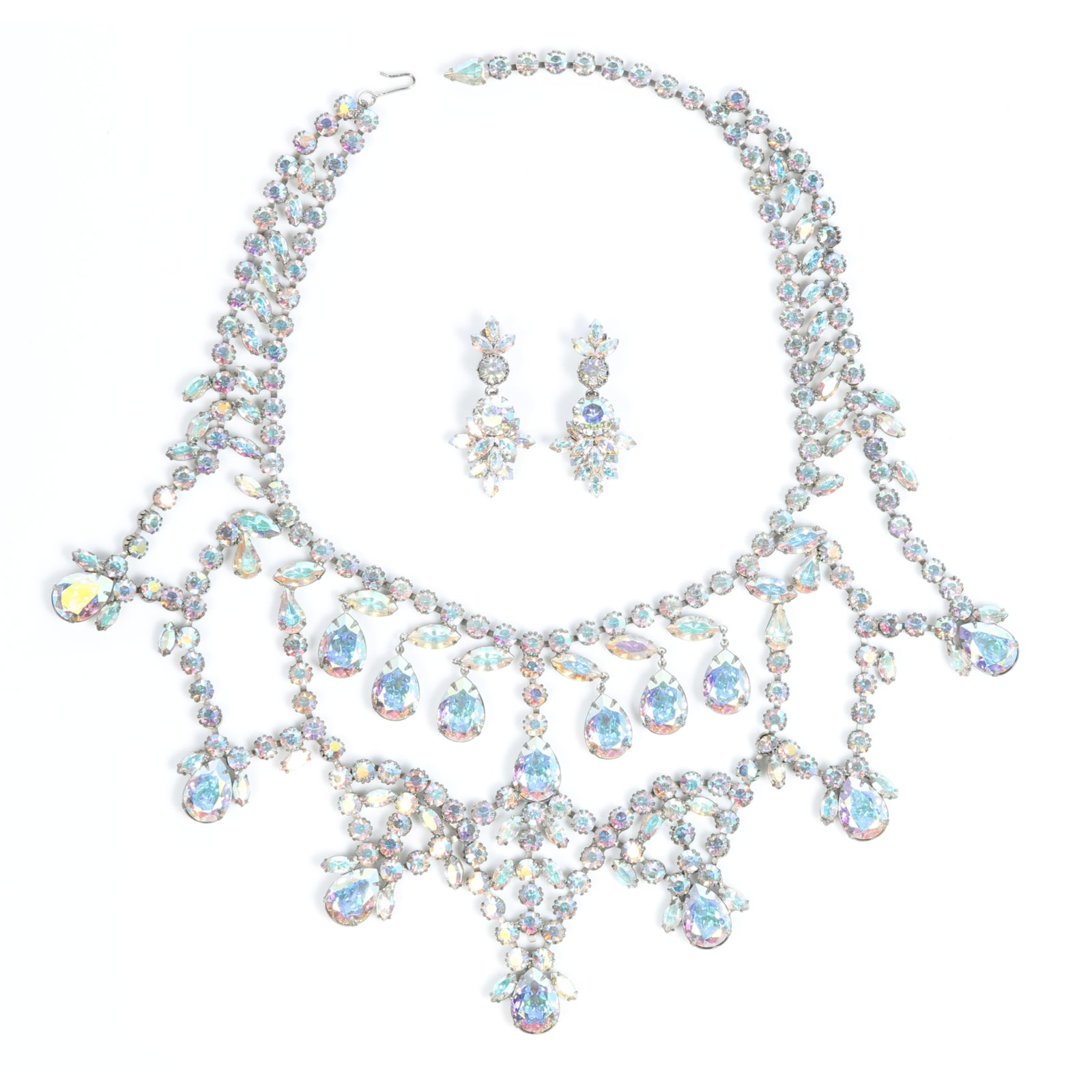Huge Austrian aurora borealis cascading bib necklace featuring pear shape crystals and matching: Huge Austrian aurora borealis cascading bib necklace featuring pear shape crystals and matching earrings Provenance: From the private collection of Dr. Claudia Brodhead 19"L x 4 1/2"W (necklace)