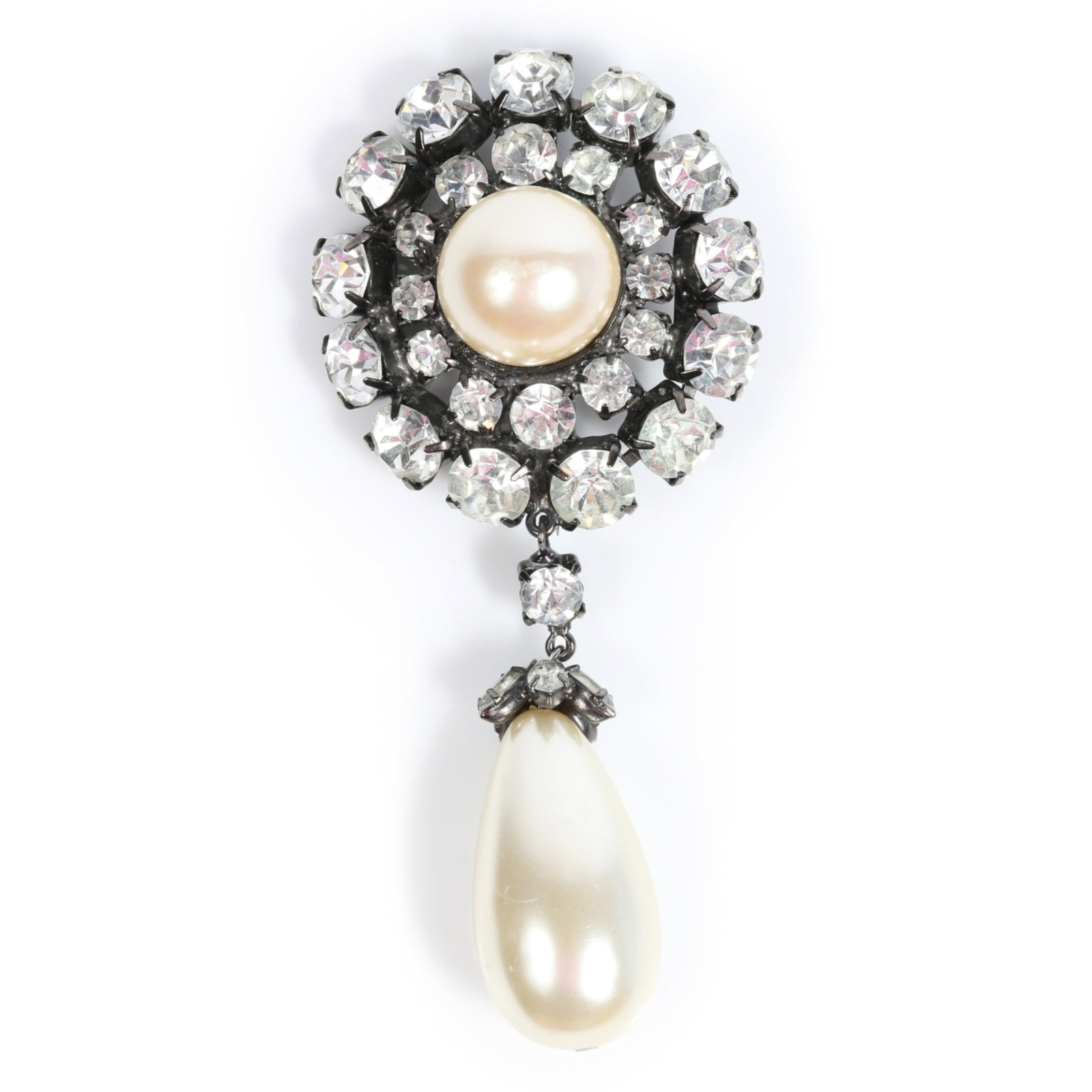Iradj Moini designer brooch featuring a monumental faux pearl drop and rhinestone crystal halo 4"H x: Iradj Moini designer brooch featuring a monumental faux pearl drop and rhinestone crystal halo Provenance: From the Collection of Joan Duran, owner of The Queen's Bedroom on Facebook 4"H x 1 3/4"W