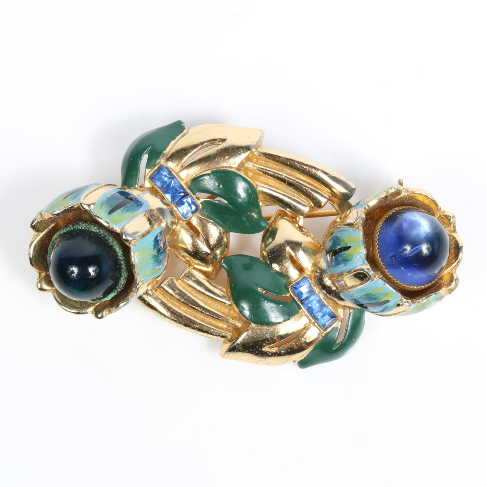 Coro Craft / Corocraft Duette Camellia gold tone brooch / dress clips with sapphire blue crystals: Coro Craft / Corocraft Duette Camellia gold tone brooch / dress clips with sapphire blue crystals and enamel leaves There's some corrosion on the metal holding one of the blue cabochon stones. Provena