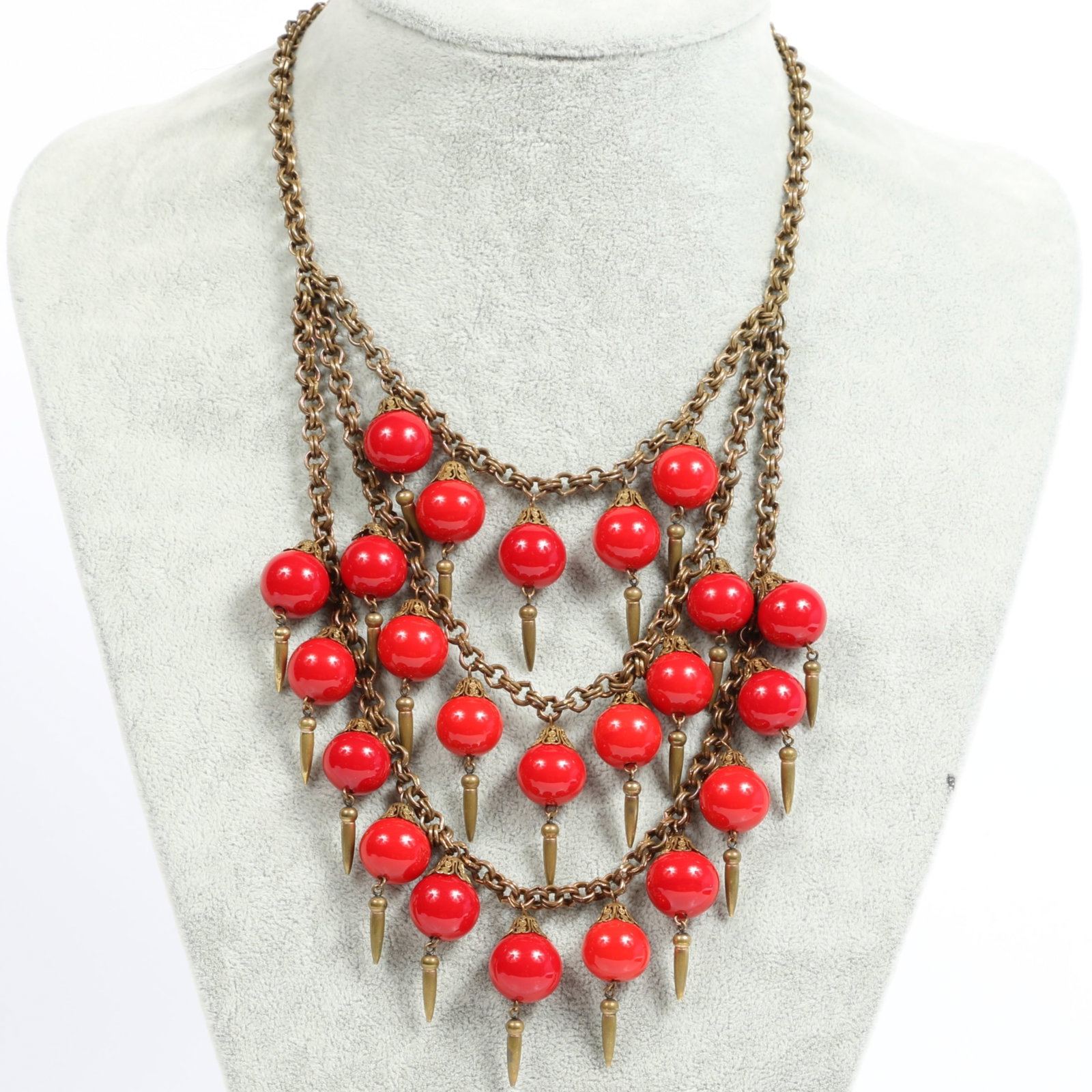 Miriam Haskell tiered festoon bib necklace with cherry red art glass beads and fringe details 16: Miriam Haskell tiered festoon bib necklace with cherry red art glass beads and fringe details Provenance: From the private collection of Dr. Claudia Brodhead 16 1/2"L x 6 1/2" Drop