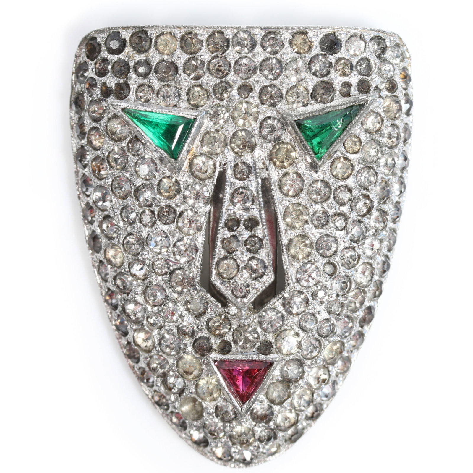 Rare KTF Trifari 1936 book piece dress clip mask with green triangular stone eyes, red stone mouth,: Rare KTF Trifari 1936 book piece dress clip mask with green triangular stone eyes, red stone mouth, and surrounded by pave rhinestones, unsigned American Costume Jewelry Vol. 2 by Carla Ginelli Brunia