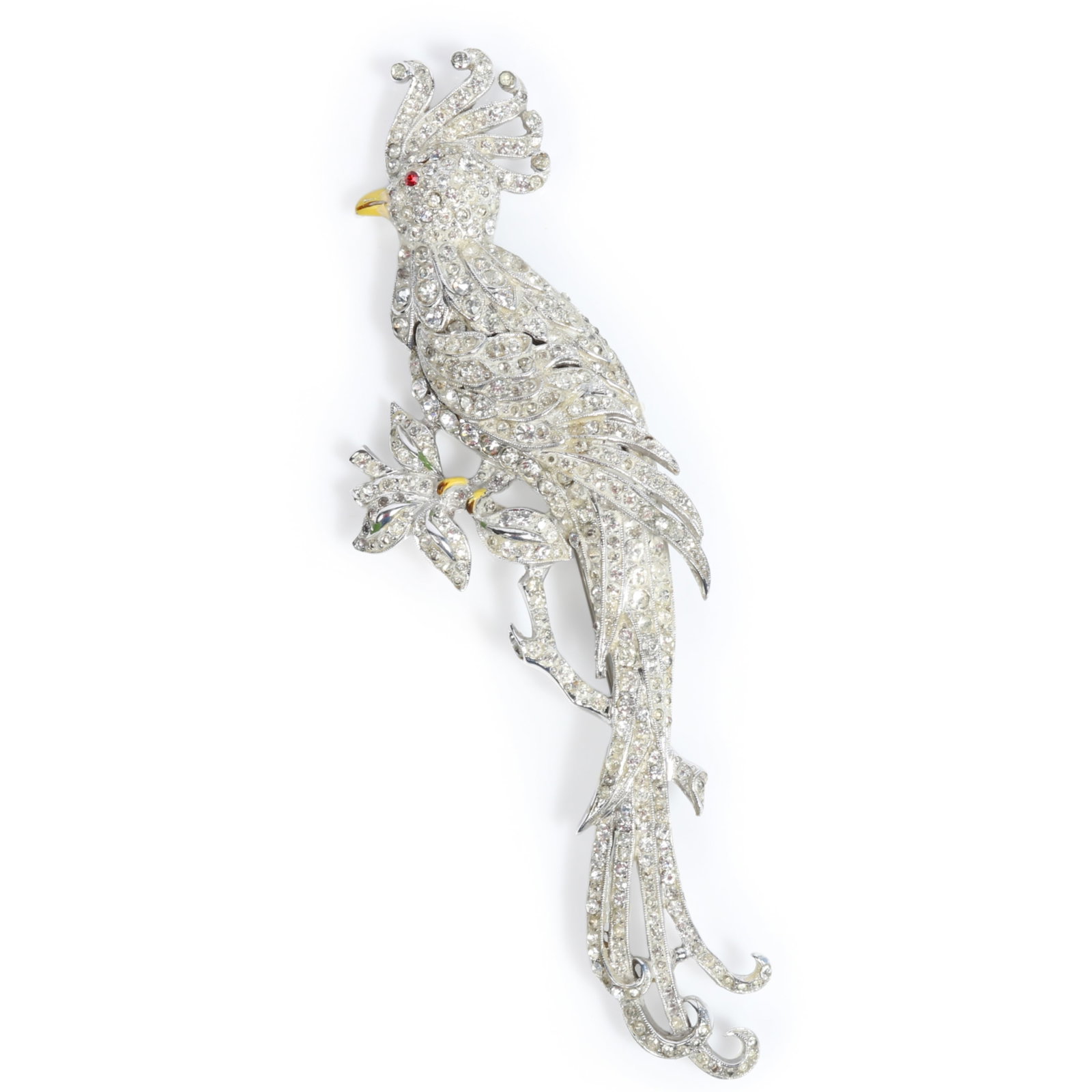 Giant Coro figural parrot bird of paradise pave brooch with red eye and yellow enamel beak 5 1/4"H x: Giant Coro figural parrot bird of paradise pave brooch with red eye and yellow enamel beak Has residue Provenance: From the private collection of Dr. Claudia Brodhead 5 1/4"H x 1 3/4"W