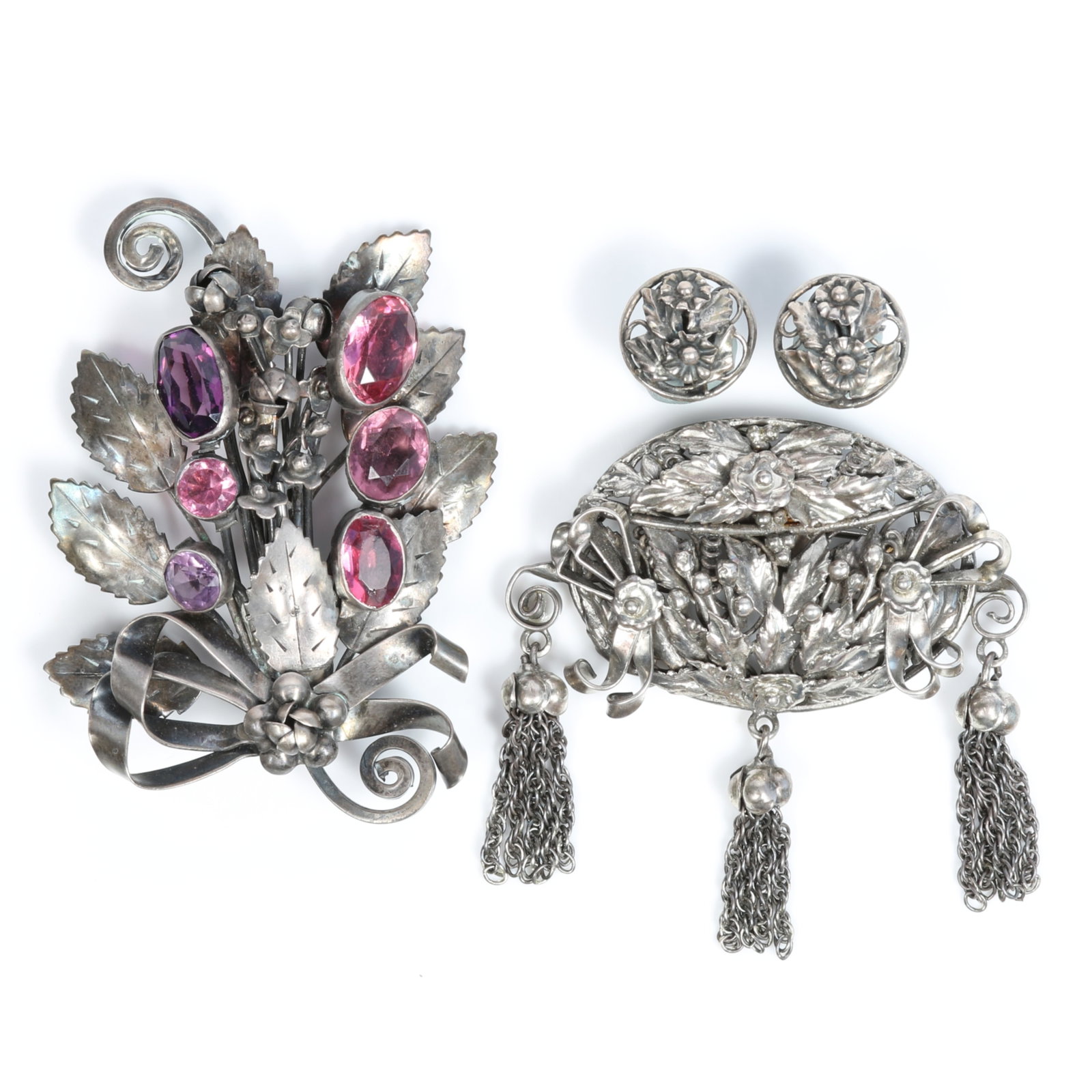Hobe sterling silver group featuring pink and purple rhinestone crystal brooch and floral brooch: Hobe sterling silver group featuring pink and purple rhinestone crystal brooch and floral brooch with fringe and matching earrings Provenance: From the private collection of Dr. Claudia Brodhead 3"H x