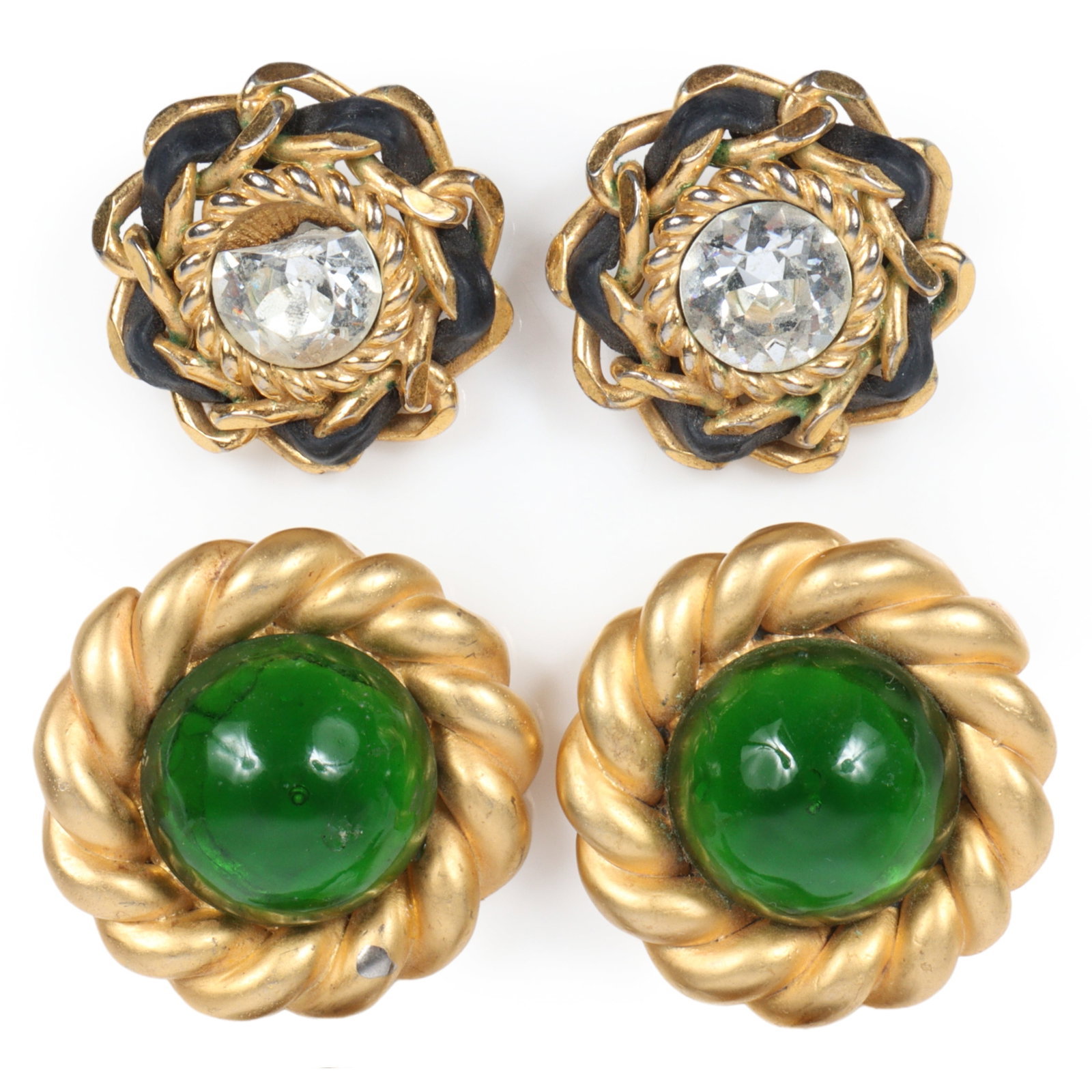 Two pairs of Chanel button earrings 2"Diam. (one green earring measured): Two pairs of Chanel button earrings Included are a pair of black leather woven chain style earrings with large center rhinestones and a pair of gold tone earrings with green lucite center accents. Gre