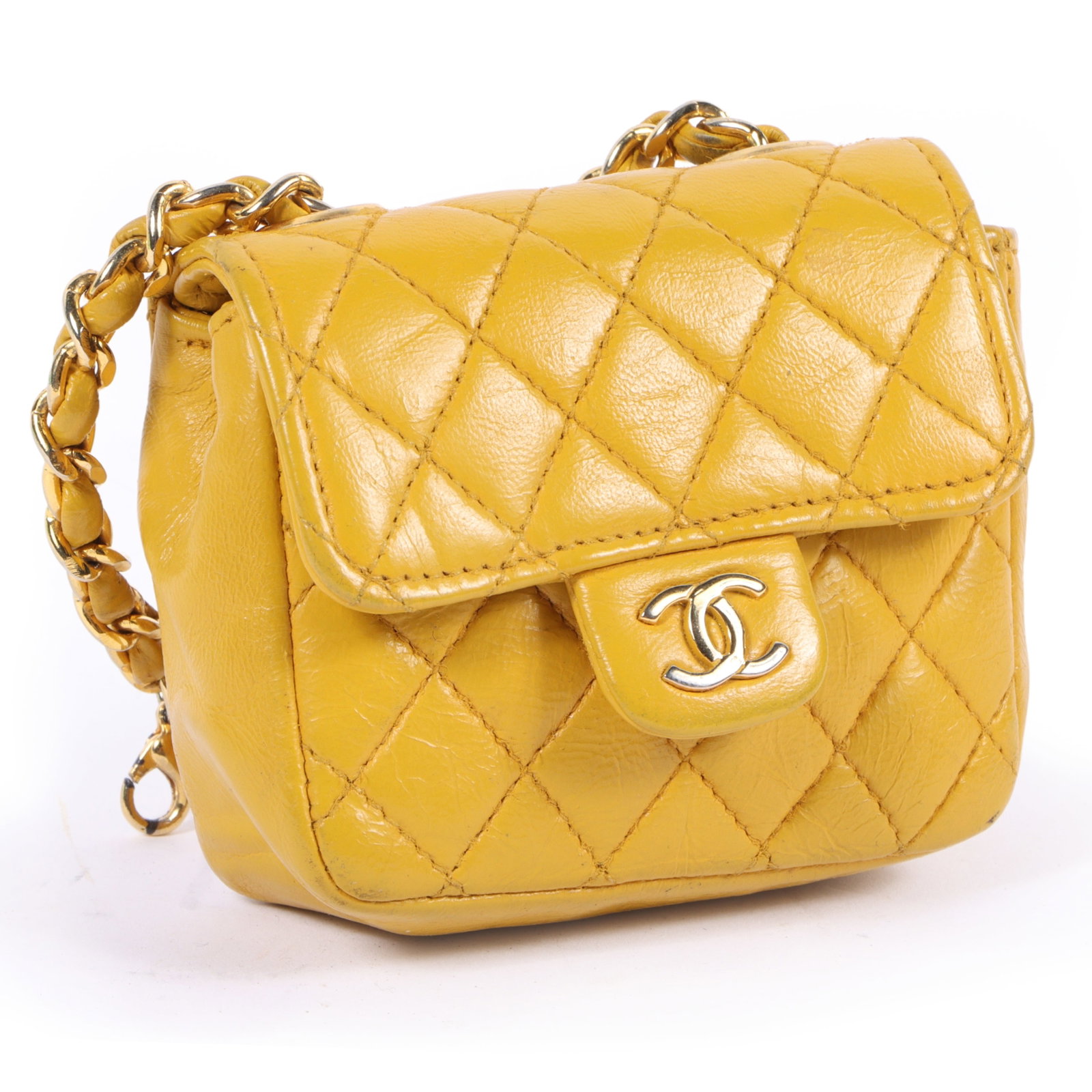 Chanel Micro mini yellow lambskin leather flap bag with gold tone hardware 3"H x 3 1/2"W x 1: Chanel Micro mini yellow lambskin leather flap bag with gold tone hardware This vibrant bag features a double CC front closure on the flap and a classic Chanel quilted body with a woven chain. Has min