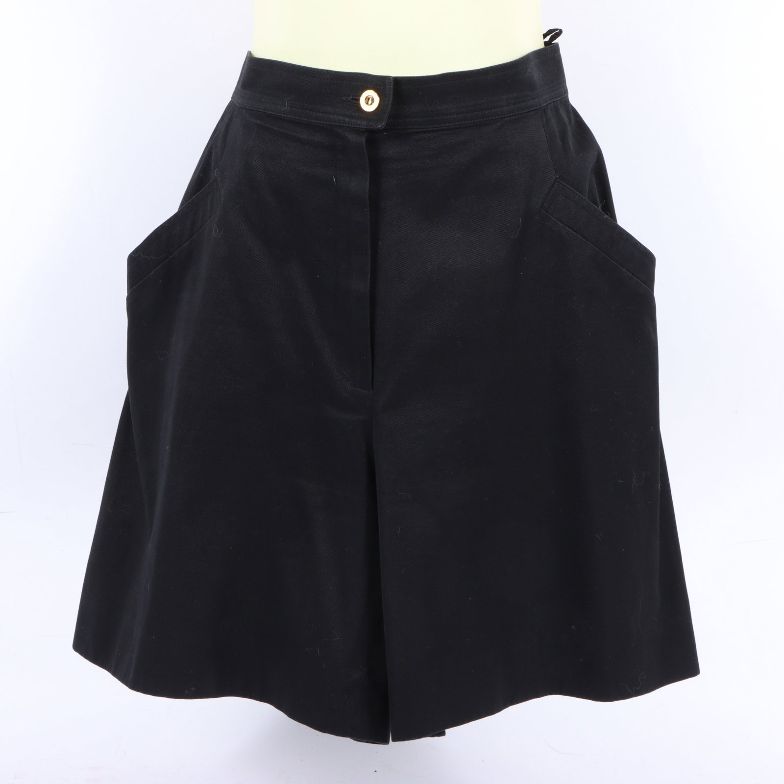 Chanel Boutique black cotton Bermuda flare shorts 14" waist, 19" length, 7" inseam, 19 1/2" outseam;: Chanel Boutique black cotton Bermuda flare shorts A pair of black shorts from the Chanel Boutique line. The cotton shorts feature a classic design with a gold tone button closure and side pockets. 14"