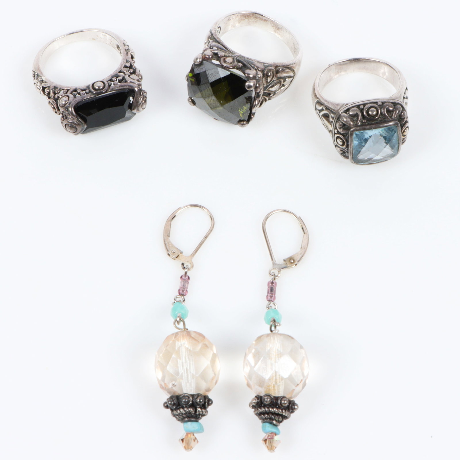 Collection of ornate sterling silver and quartz and tourmaline crystal jewelry, 4pc. 2 1/2"H x 1/2"W: Collection of ornate sterling silver and quartz and tourmaline crystal jewelry, 4pc. Includes three 925 Mexican? sterling rings with faceted semi precious stones and dangle earrings. black stone ring: