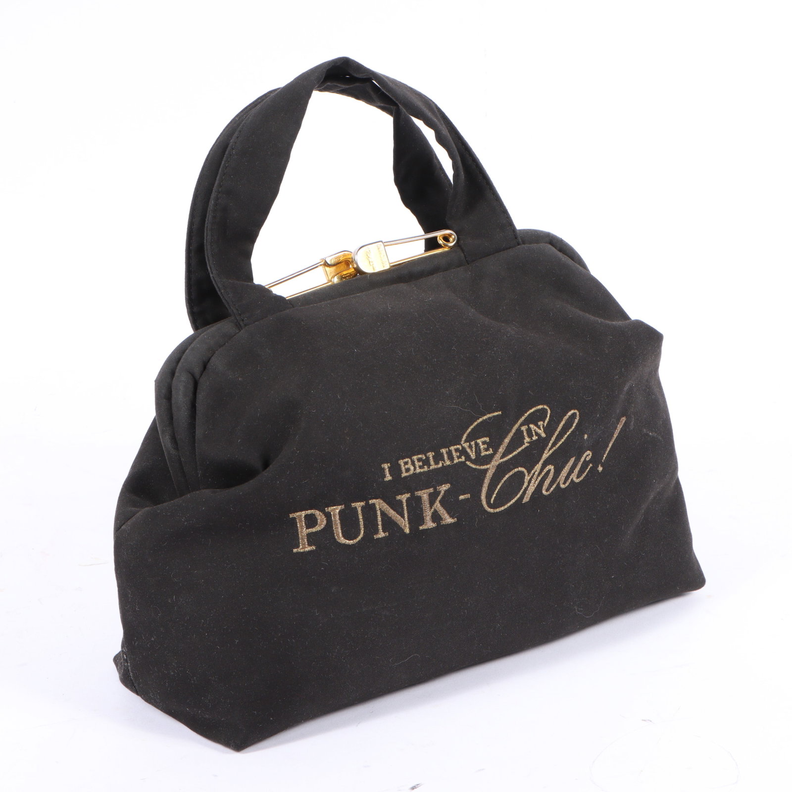 Moschino "I Believe in Punk Chic!" black canvas handbag 9"H x 10"W x 5"D(body), 4 3/4"Handle drop: Moschino "I Believe in Punk Chic!" black canvas handbag This black canvas bag features a hinged, flap opening with gold tone hardware. It has an exterior zipper accent with a razor blade style accent.