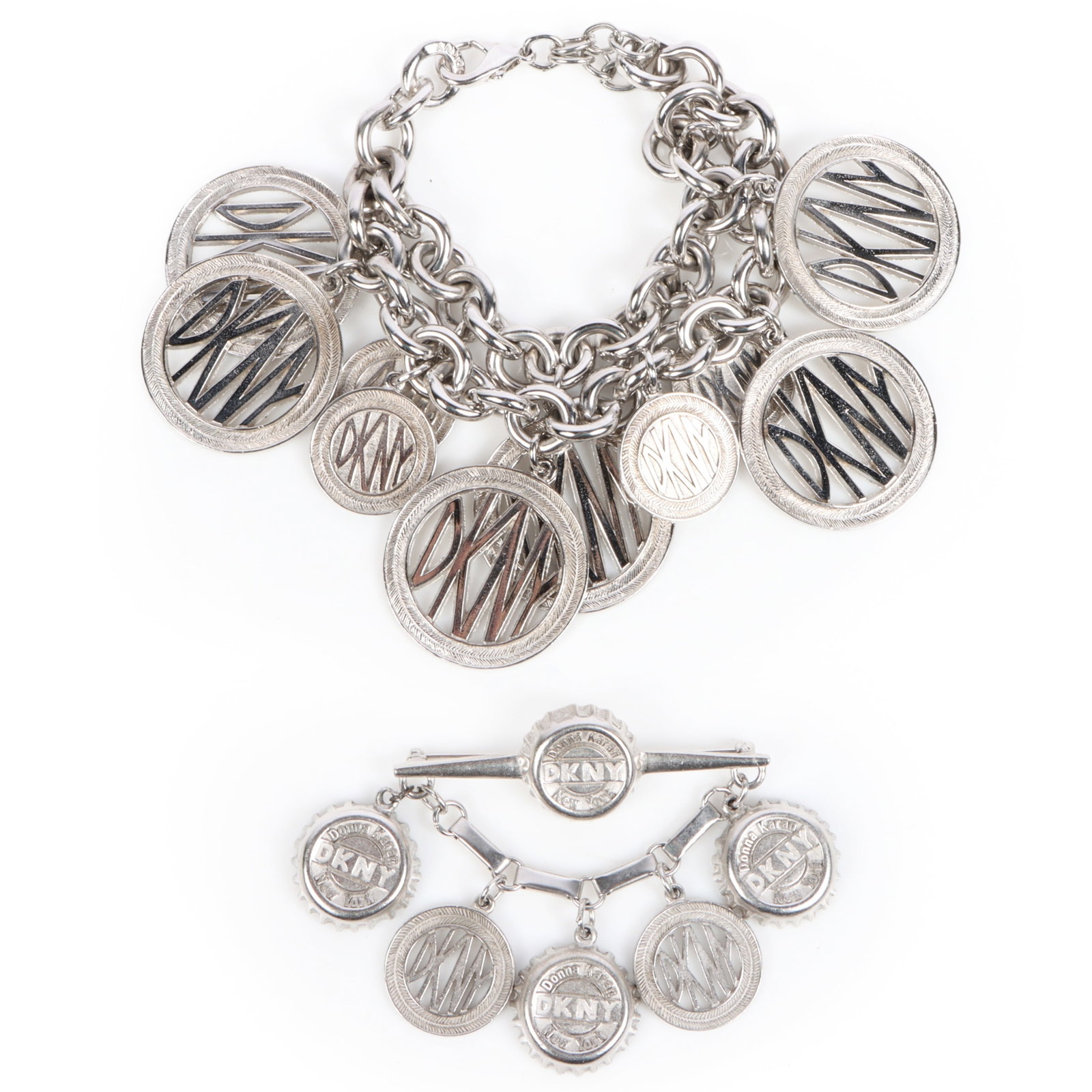 2pc. DKNY silver tone bracelet and pin brooch 9"Long x 2 1/2"W (bracelet): 2pc. DKNY silver tone bracelet and pin brooch Provenance: From the private collection of Dr. Claudia Brodhead 9"Long x 2 1/2"W (bracelet)