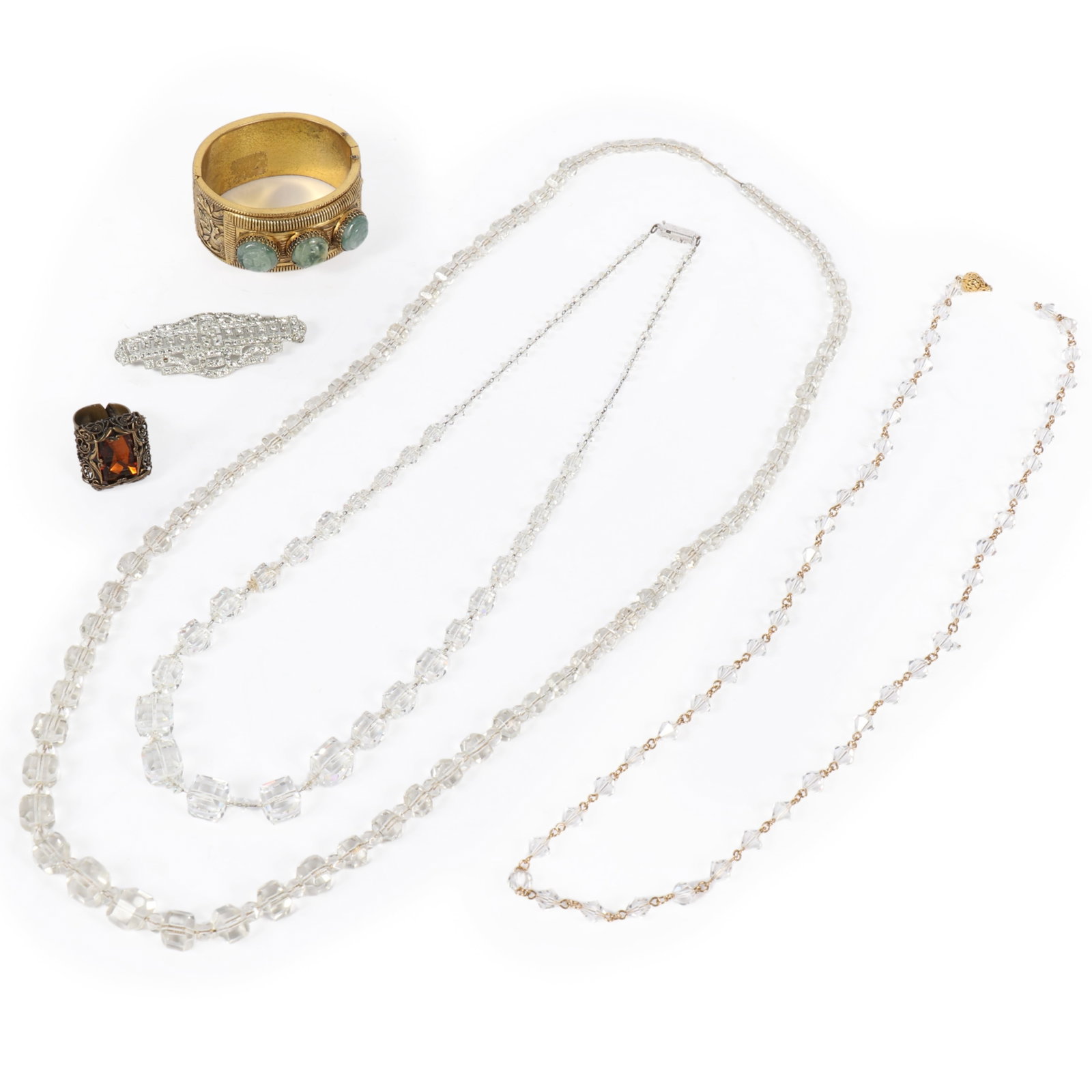 Vintage costume jewelry 6pc.; 3 French? facted crystal prism necklaces, brass filigree adjustable: Vintage costume jewelry 6pc.; 3 French? facted crystal prism necklaces, brass filigree adjustable ring with orange stone, Art Deco rhinestone brooch, and a brass hinged cuff bracelet with carved green