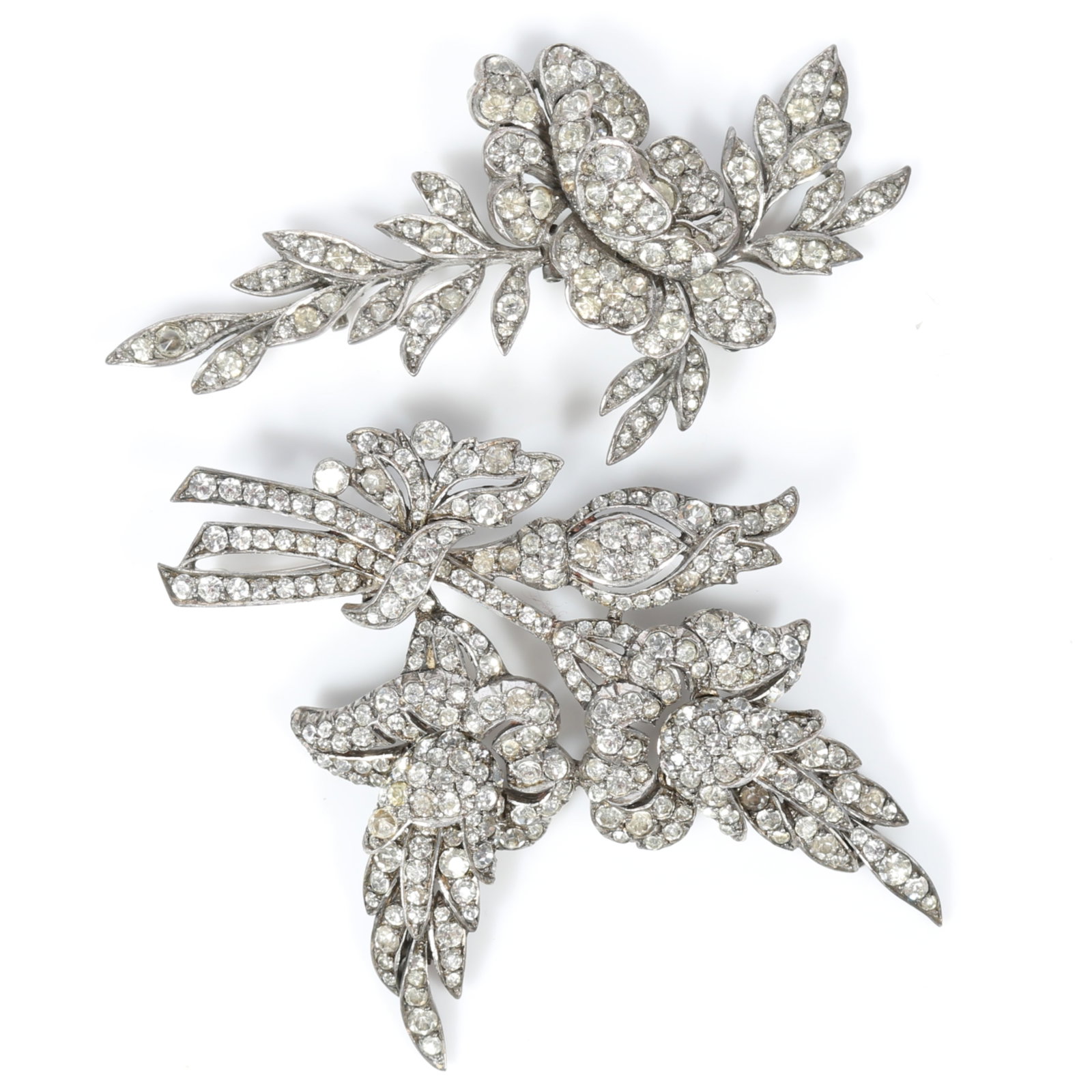 Pair of Ciro of Bond Street English Art Deco silver articulated hand cut paste stone floral brooches: Pair of Ciro of Bond Street English Art Deco silver articulated hand cut paste stone floral brooches Both signed "CP England" Larger has one missing stone and one replaced stone, smaller has 2 small m
